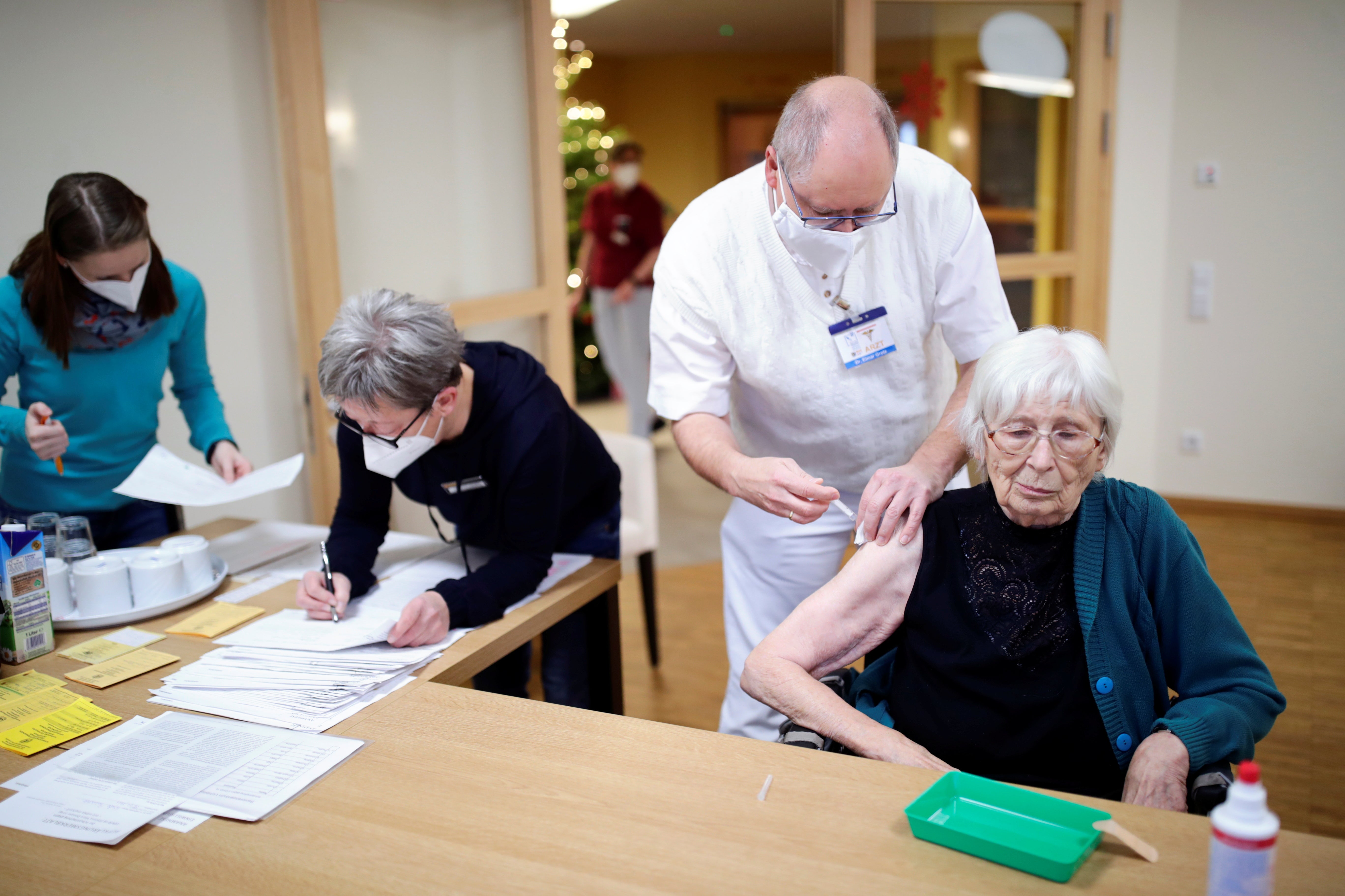 An elderly woman receives the Pfizer-BioNTech coronavirus disease (COVID-19) vaccine at a nursing home in Burgbernheim, Germany, December 28, 2020