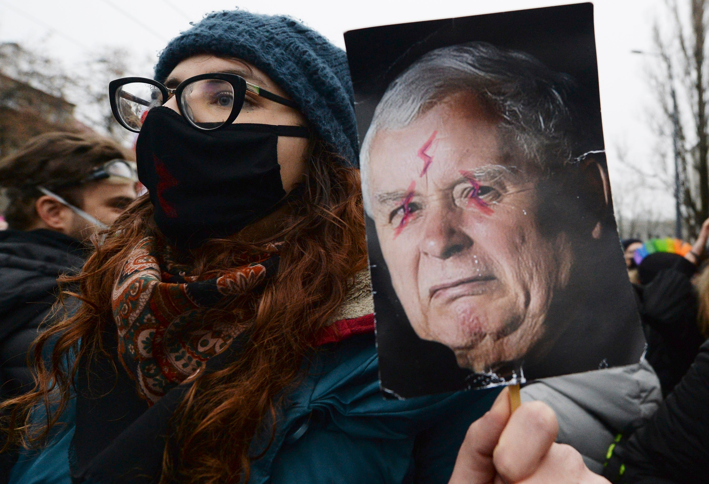 Anti-government protesters hold up images of the ruling party leader, Jaroslaw Kaczynski, in Warsaw, earlier this month (AP Photo/Czarek Sokolowski)