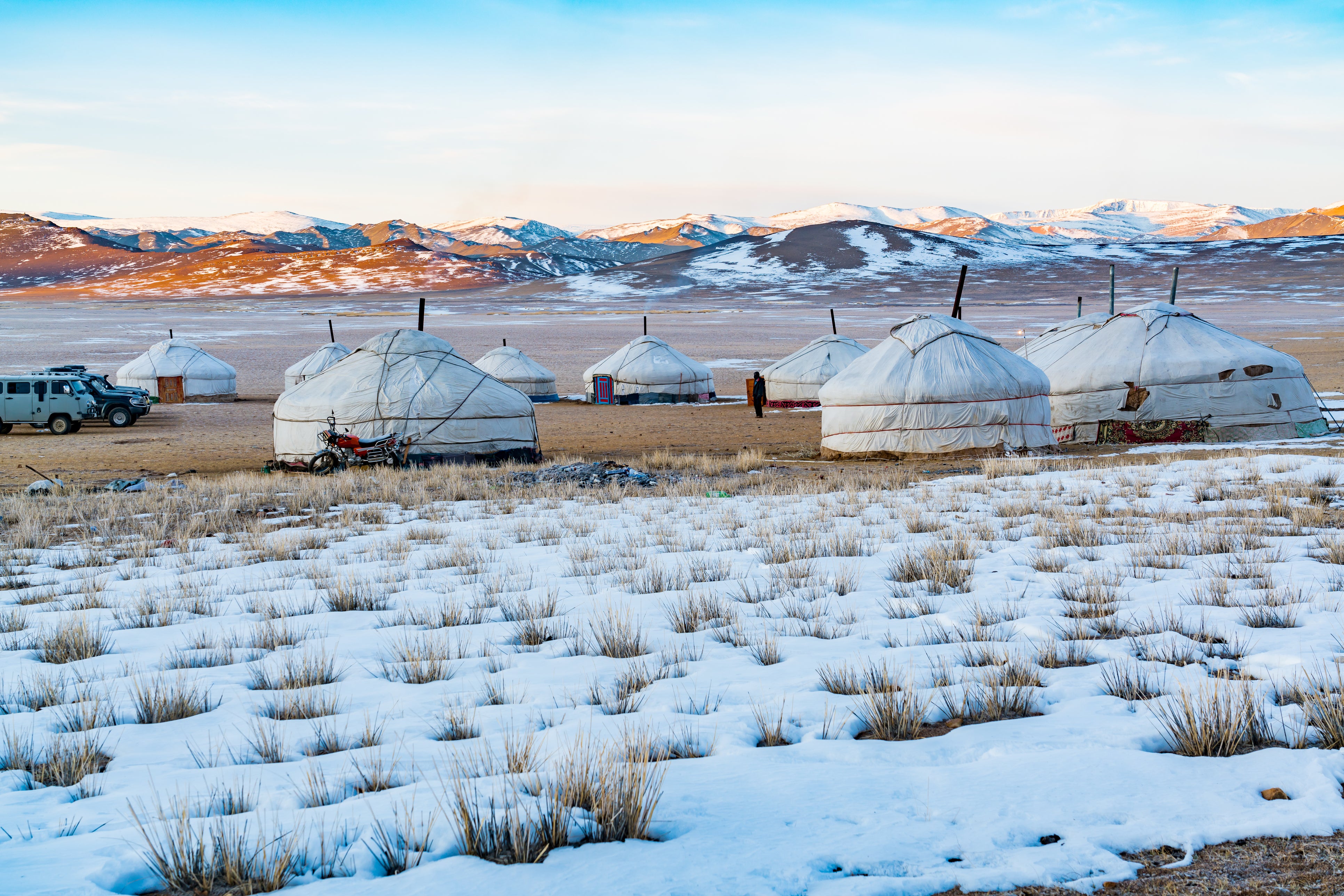 View of Mongolian Ger on the snowy steppe in the morning with the beautiful mountain in the background at Ulgii in Mongolia