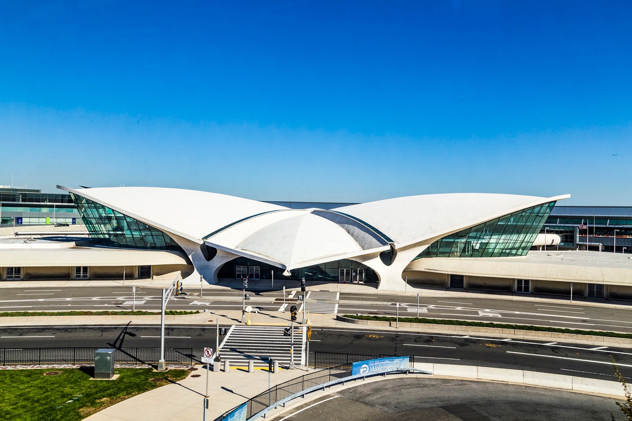 A man fled New York JFK airport after a loaded gun was found in his carry on bag