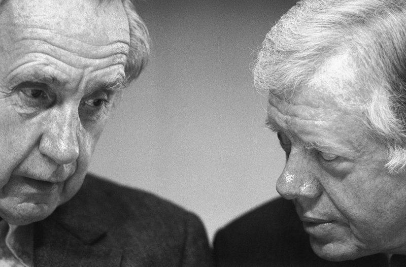 Sir Brian Urquhart, former under secretary-general of the United Nations, left, and former President Jimmy Carter confer during the opening session of a Middle East conference held at the Carter Center in Atlanta, Ga.