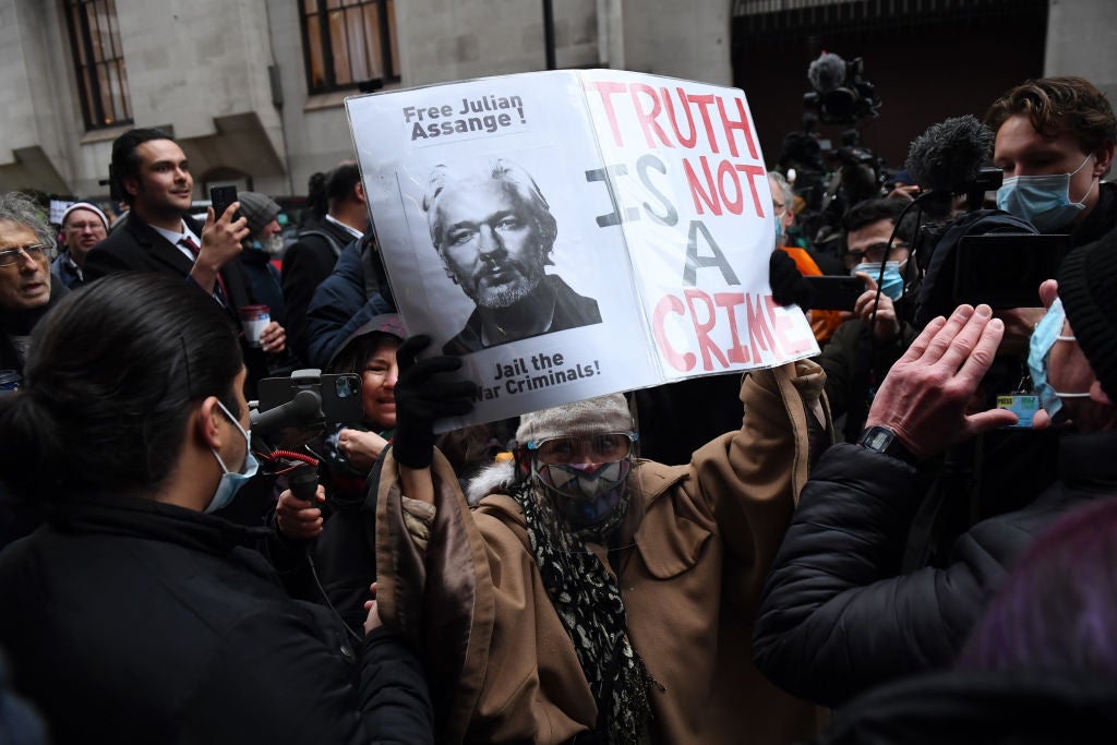 Supporters of Julian Assange celebrate after the verdict outside the Old Bailey