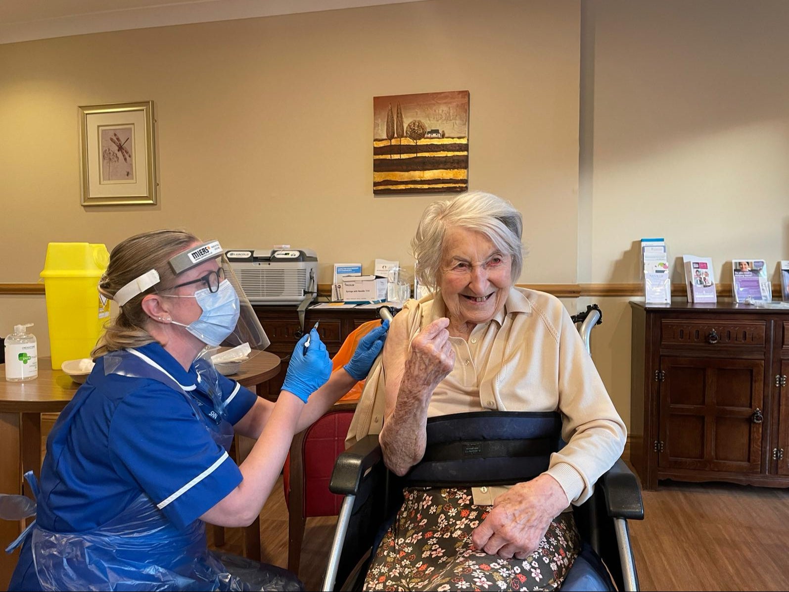 Handout photo of 104-year-old Joyce Birrell receiving the Pfizer/BioNtech covid-19 vaccine at Foxholes Care Home in Hertfordshire