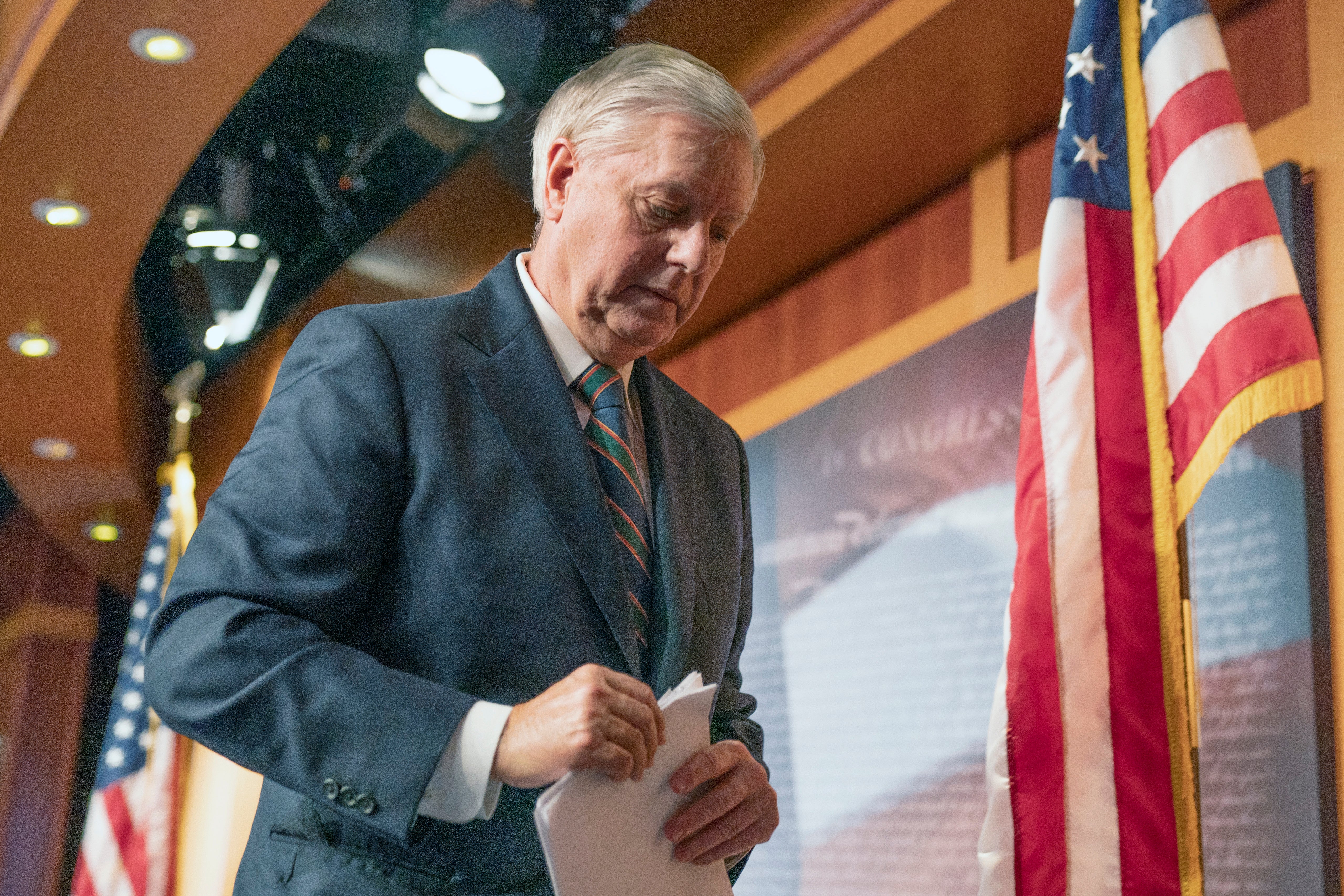 Lindsey Graham walks away after speaking to reporter on 7 January about Capitol violence.