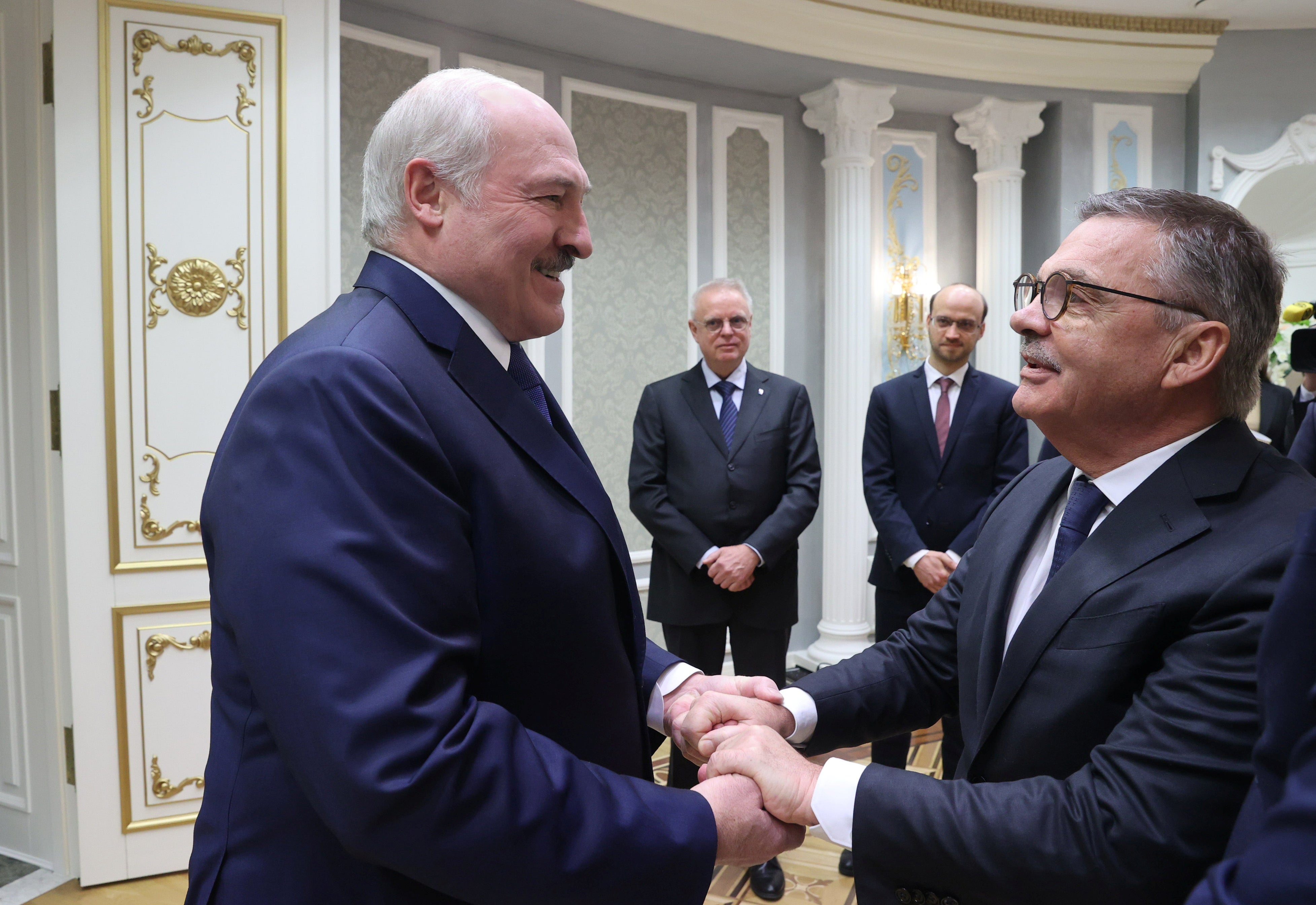 Very pleased to meet you: Belarusian President Alexander Lukashenko greets International Ice Hockey Federation President Rene Fasel (Nikolai Petrov/BelTA/Handout via REUTERS)