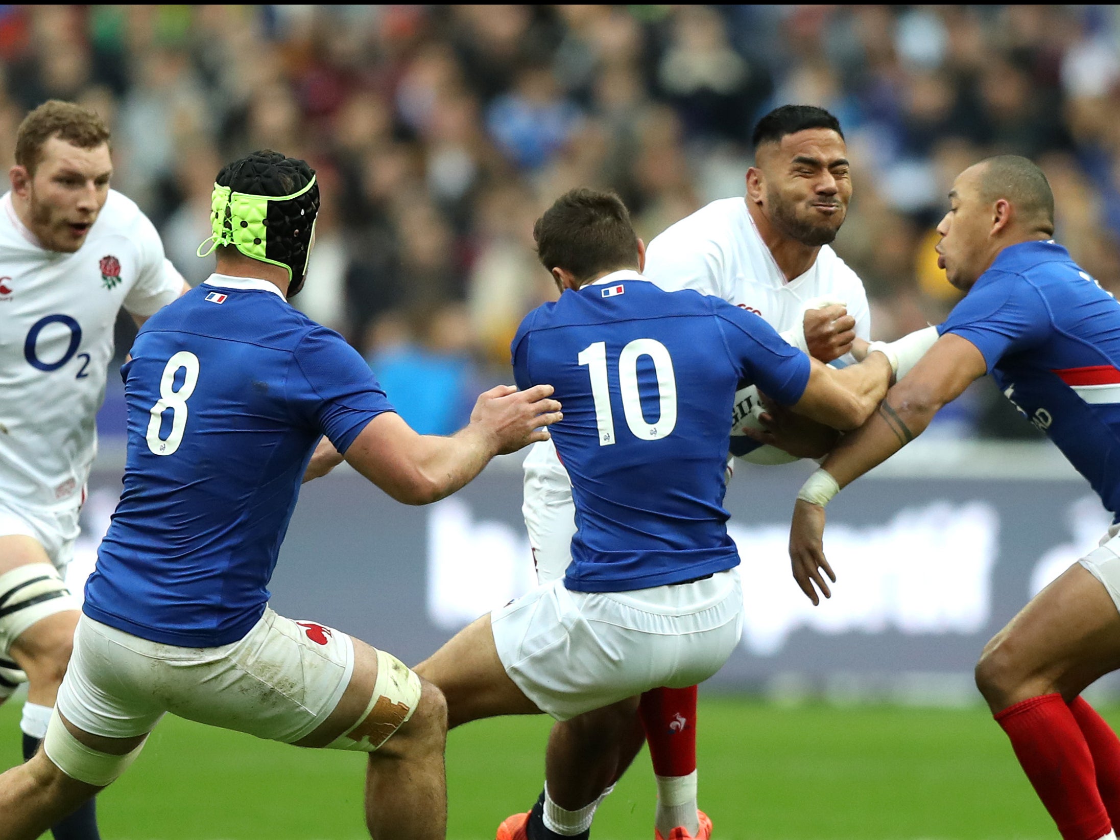 Manu Tuilagi is tackled by Romain Ntamack and Gael Fickou at the 2020 Six Nations