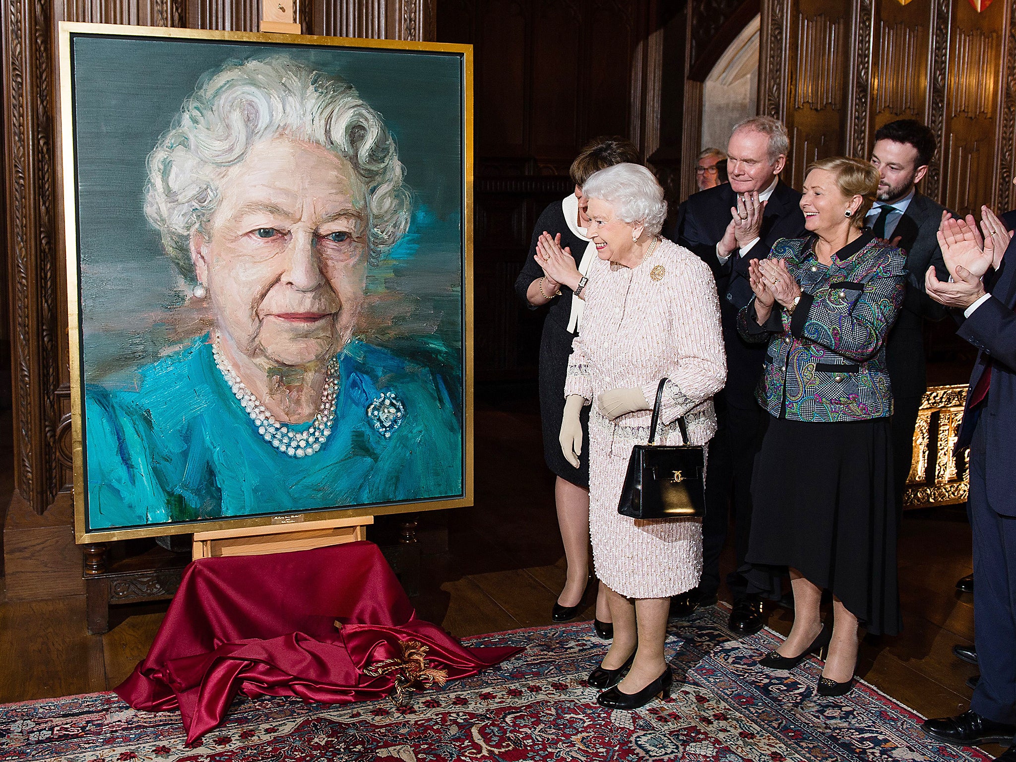 Queen Elizabeth II, Martin McGuinness, deputy first minister of Northern Ireland, and Frances Fitzgerald, Ireland’s minister of justice and equality, unveil a portrait of Queen Elizabeth II by artist Colin Davidson