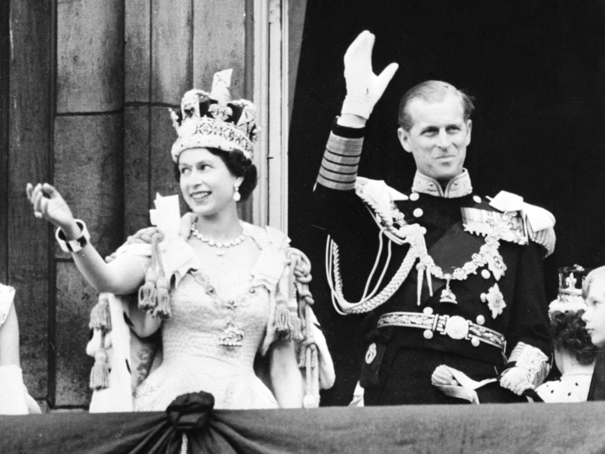 The Queen, accompanied by Prince Philip, waves to the crowd after her coronation at Westminster Abbey on 2 June 1953