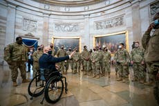 A day of historic impeachment, a Capitol as armed encampment