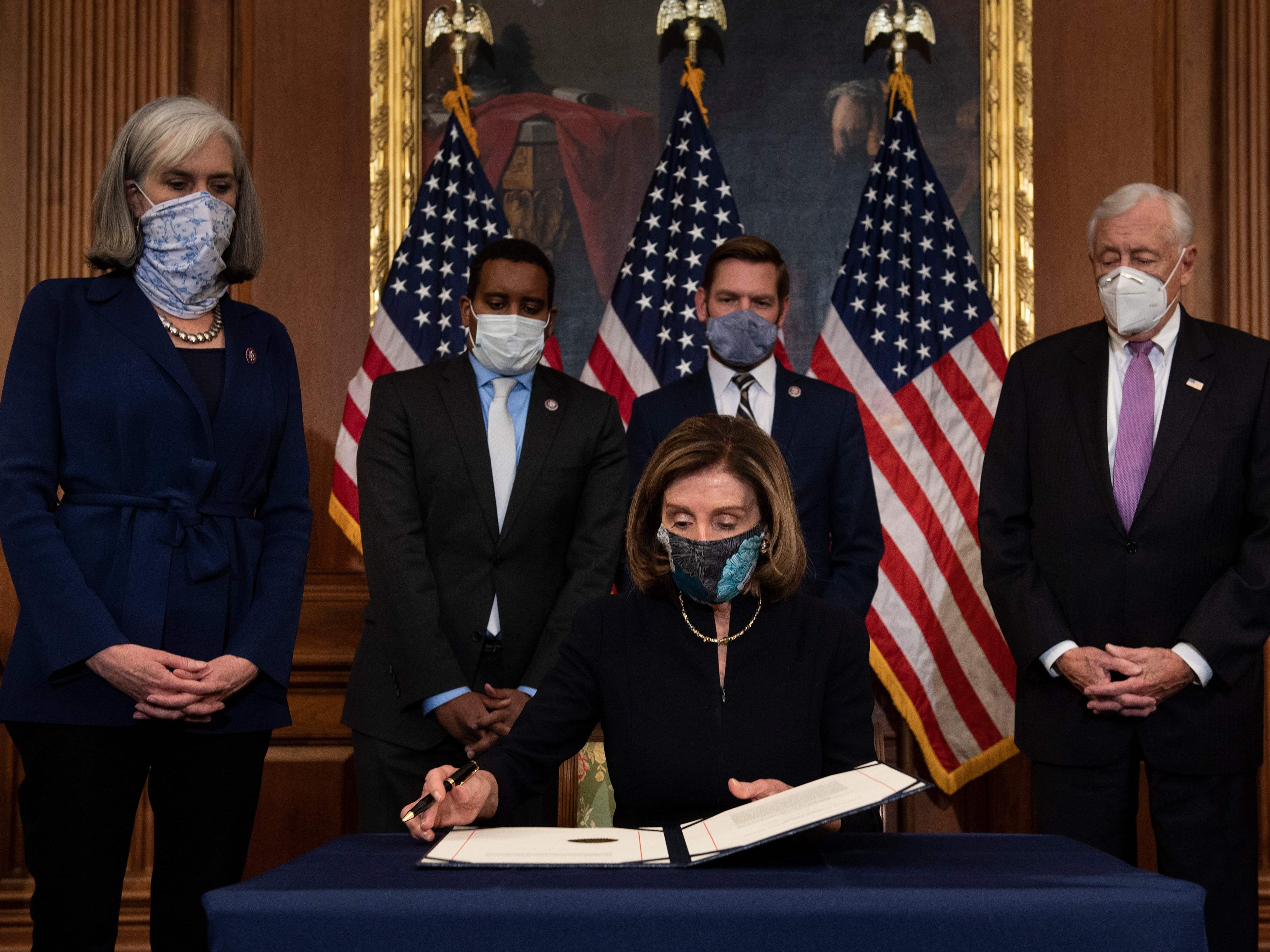 Speaker of the House Nancy Pelosi (D-CA) prepares to sign the article of impeachment during an engrossment ceremony after the US House of Representatives voted to impeach the US President Donald Trump at the US Capitol, January 13, 2021, in Washington, DC.