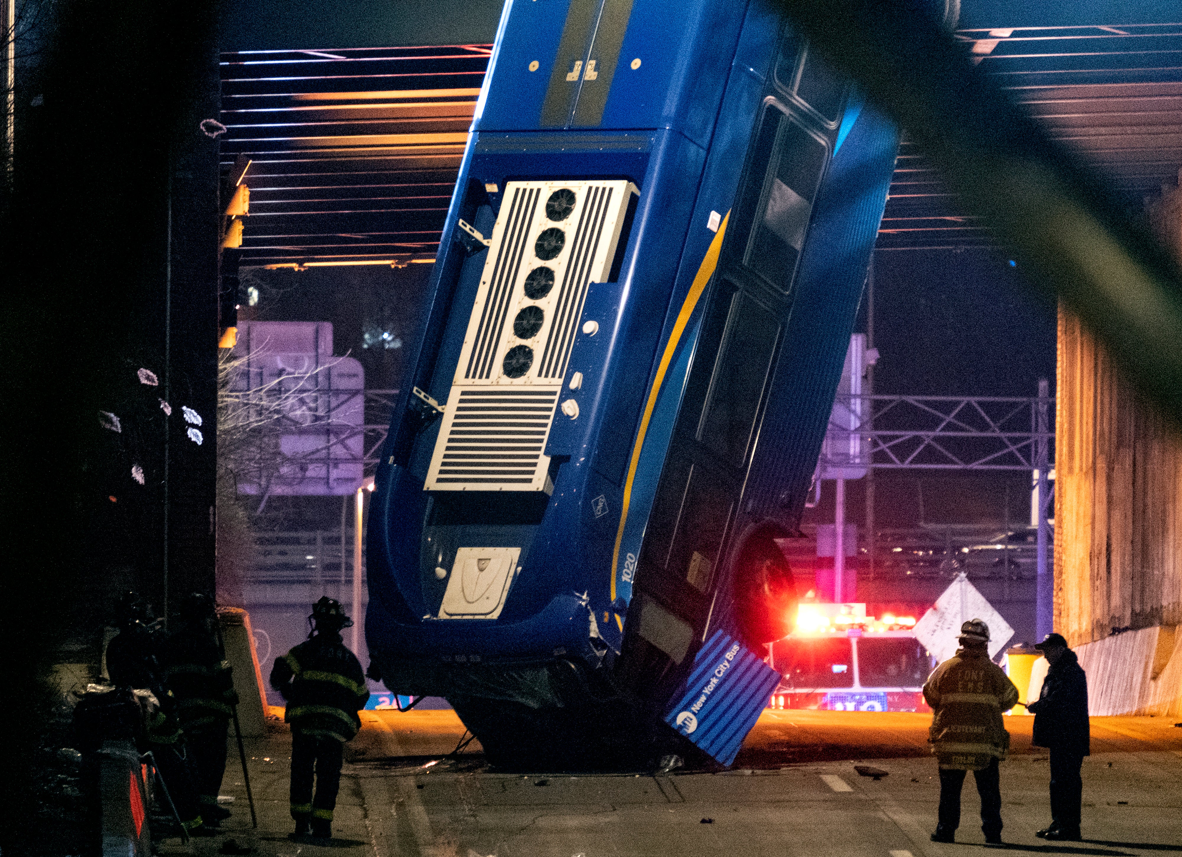 New York bus left dangling over bridge after crash