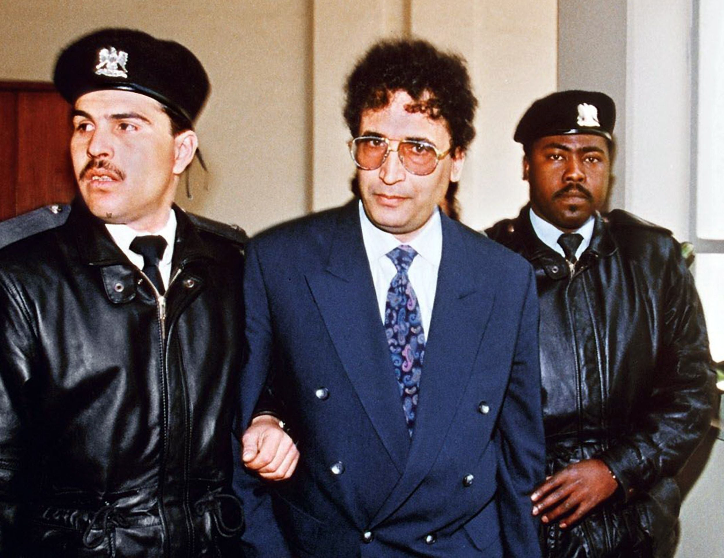 Abdelbaset Ali Mohmet al-Megrahi, later convicted of the Lockerbie bombing, is escorted by security officers on 18 February, 1992.