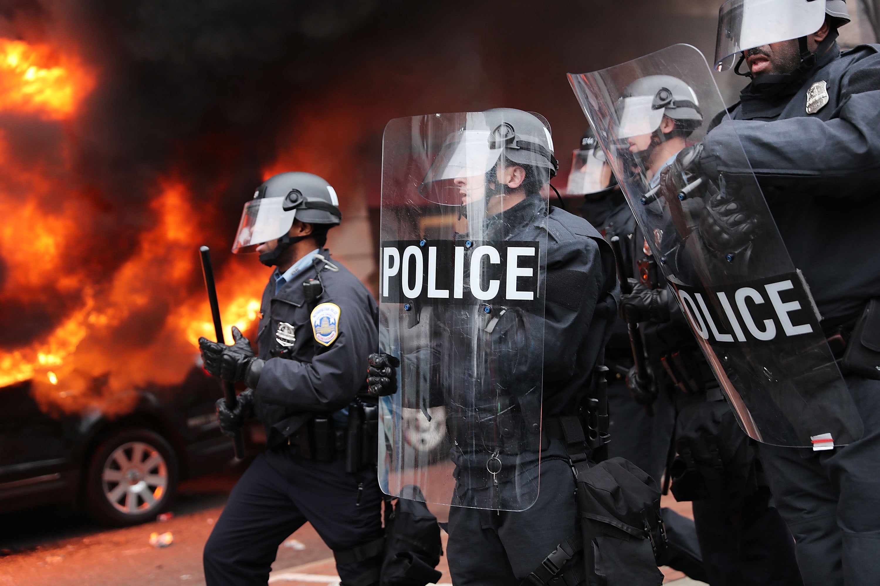 Police in riot gear move towards demonstrators in downtown Washington DC after a limousine was set on fire during Donald Trump’s inauguration.