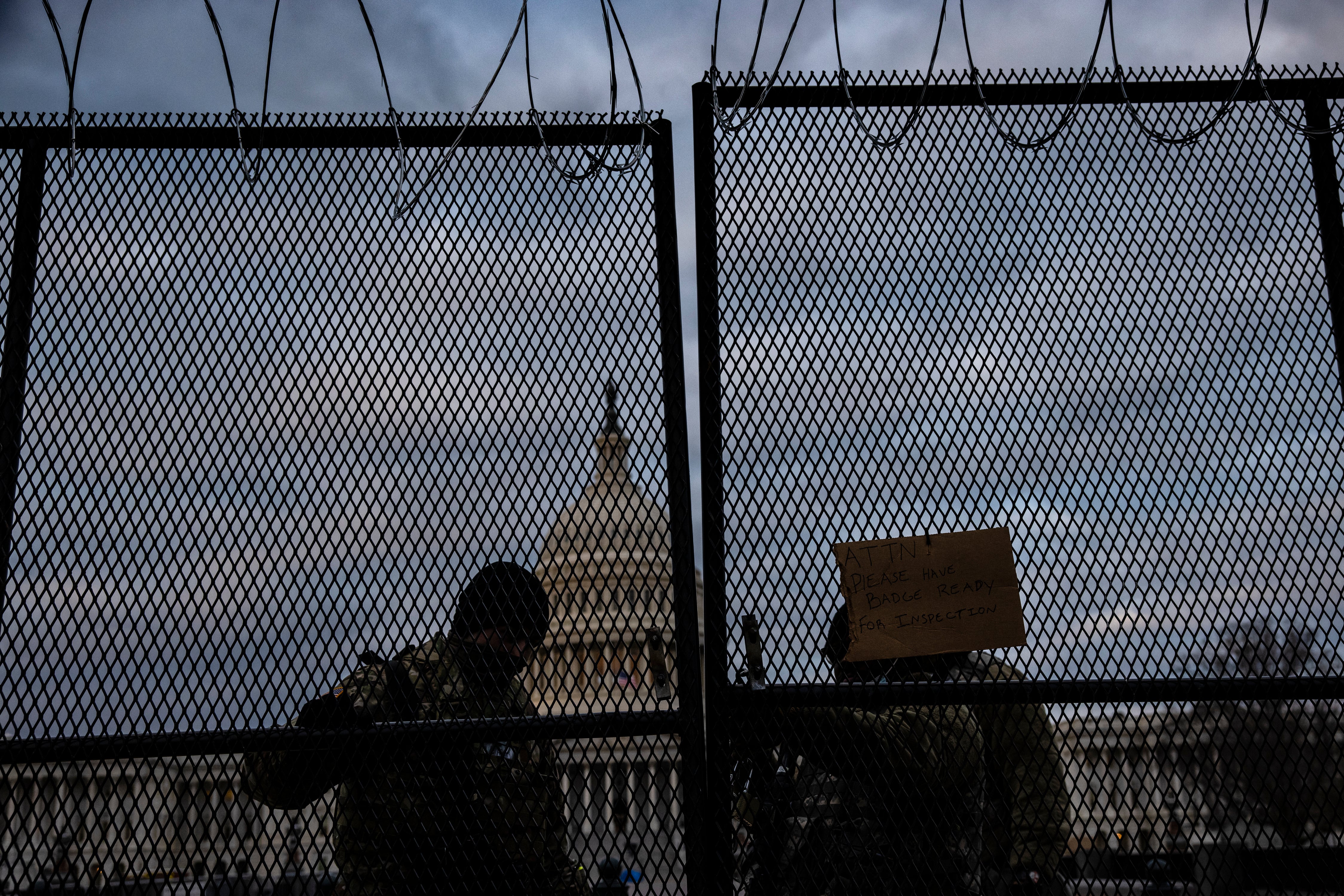 WASHINGTON, DC - JANUARY 17: National Guard soldiers secure a gate to the east front of the U.S. Capitol on the morning of January 17, 2021 in Washington, DC. After last week's riots at the U.S. Capitol Building, the FBI has warned of additional threats in the nation's capital and in all 50 states. According to reports, as many as 25,000 National Guard soldiers will be guarding the city as preparations are made for the inauguration of Joe Biden as the 46th U.S. President. (Photo by Samuel Corum/Getty Images)