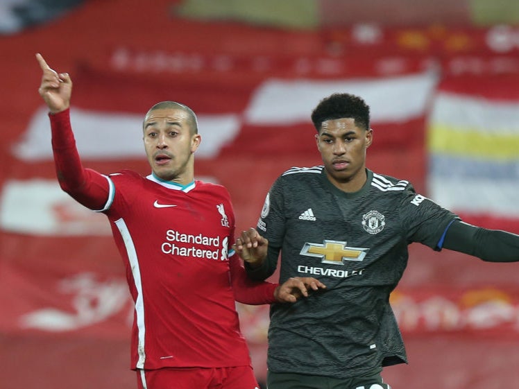 Marcus Rashford in action with Thiago Alcantara