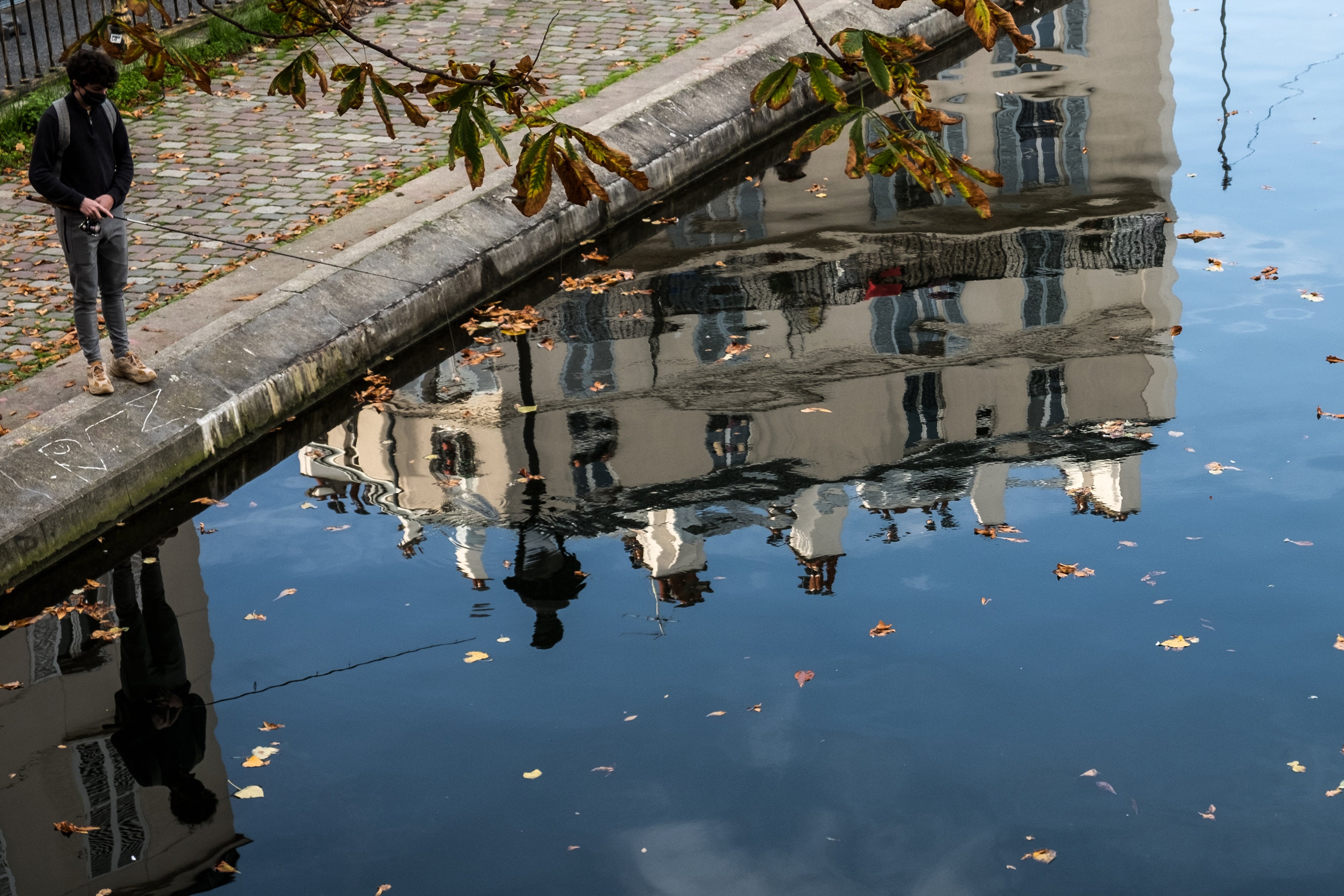 A man fishes by the Seine in Paris during lockdown in November 2020