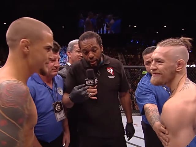 <p>Dustin Poirier (left) and Conor McGregor square off ahead of their 2014 clash</p>