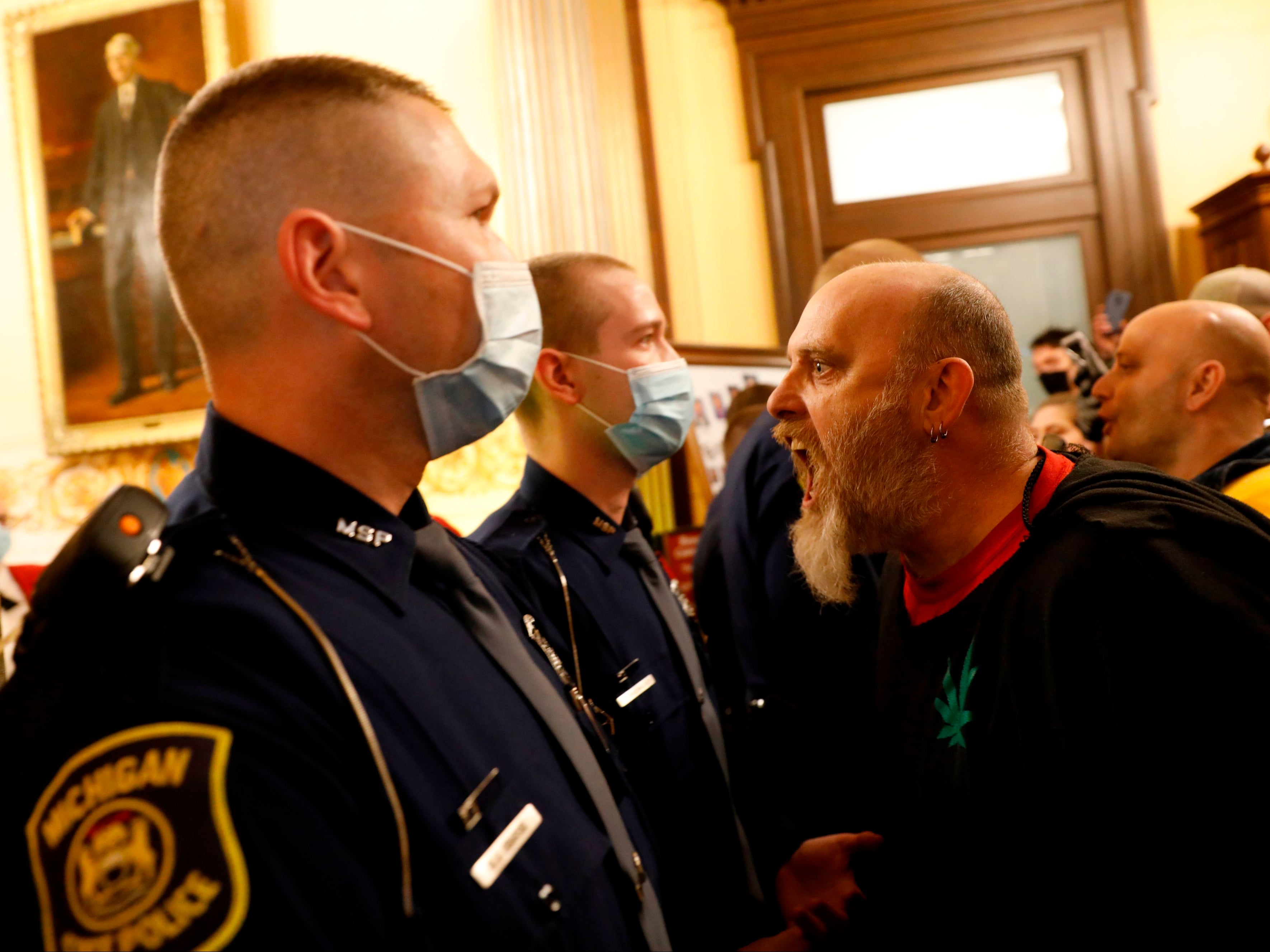 Protesters against Gov Whitmer’s policies to contain the pandemic at Michigan’s state capitol in Lansing in April 2020