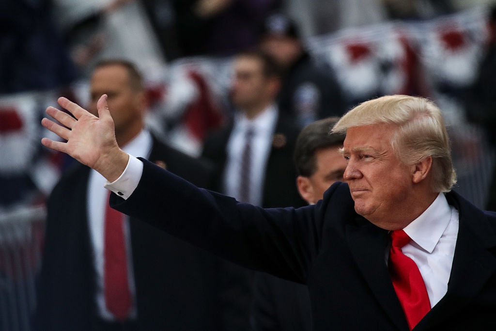 President Donald Trump waves to supporters as he walks the parade route during the Inaugural Parade on 20 January 2017 in Washington, DC