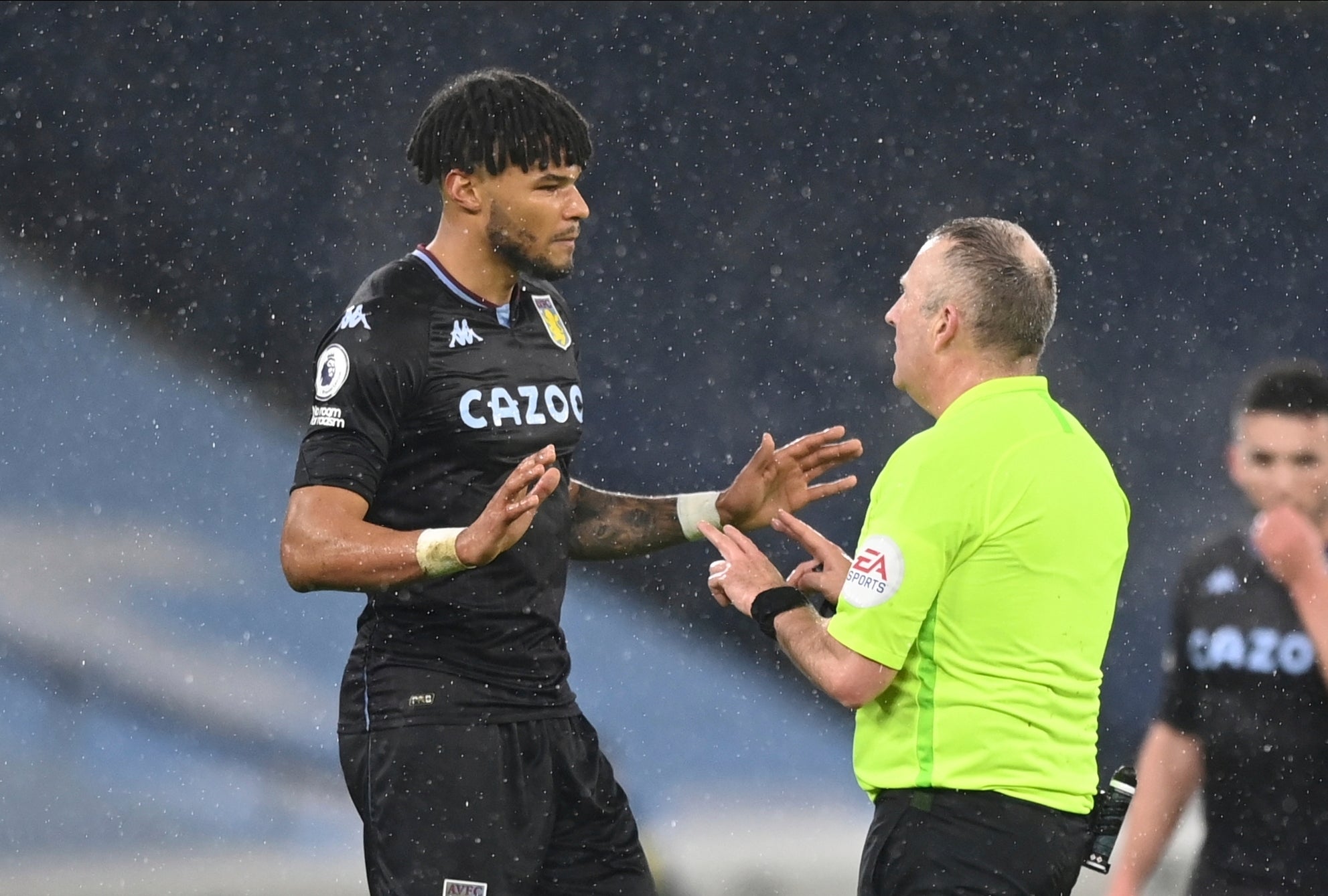 Tyrone Mings speaks to referee Jon Moss