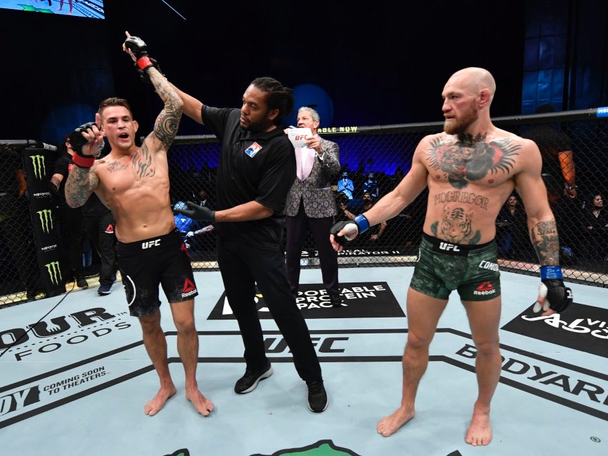 Dustin Poirier (left) celebrates beating Conor McGregor in Abu Dhabi on Saturday