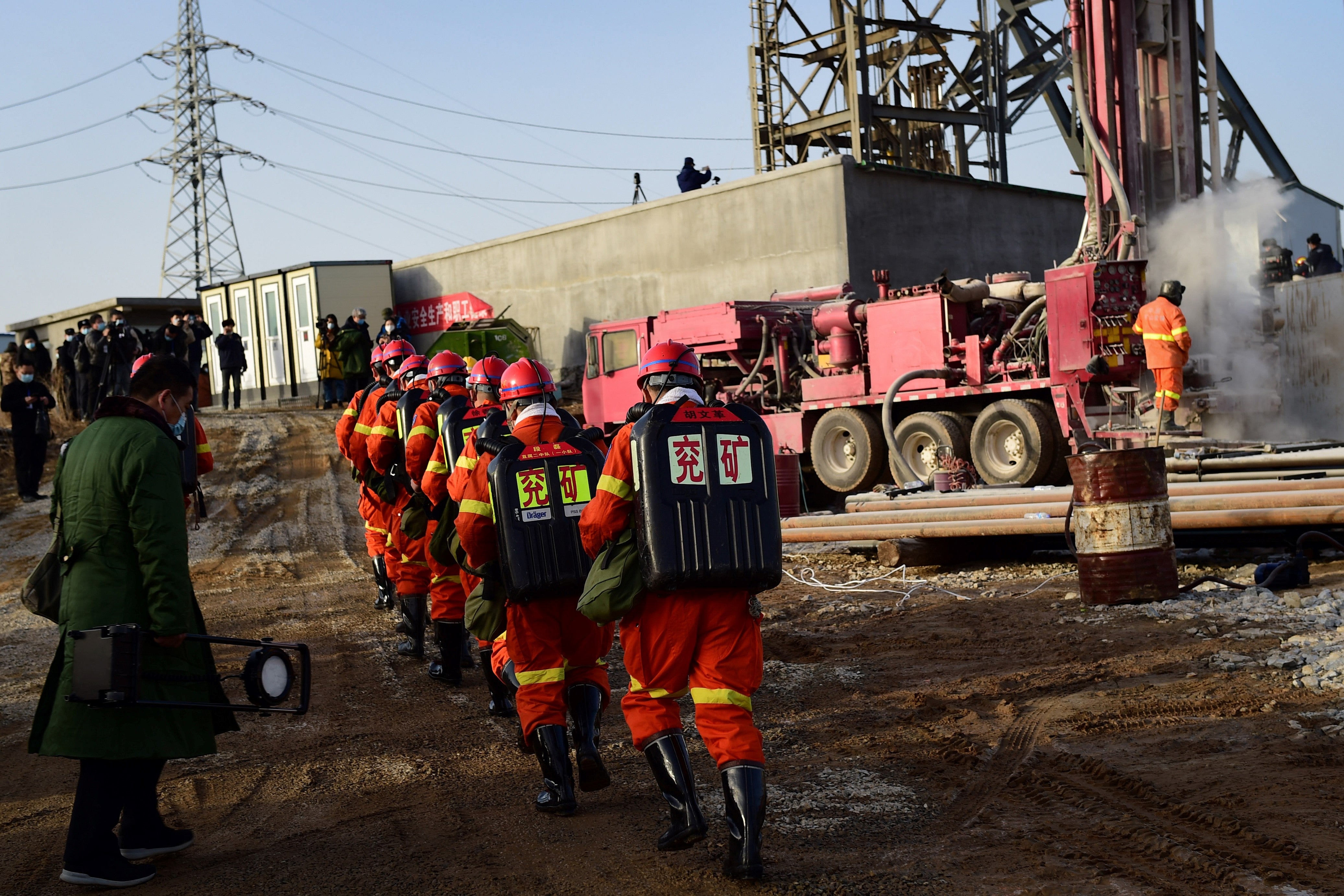 Rescuers working at the site of gold mine explosion where 22 miners were trapped underground in Qixia