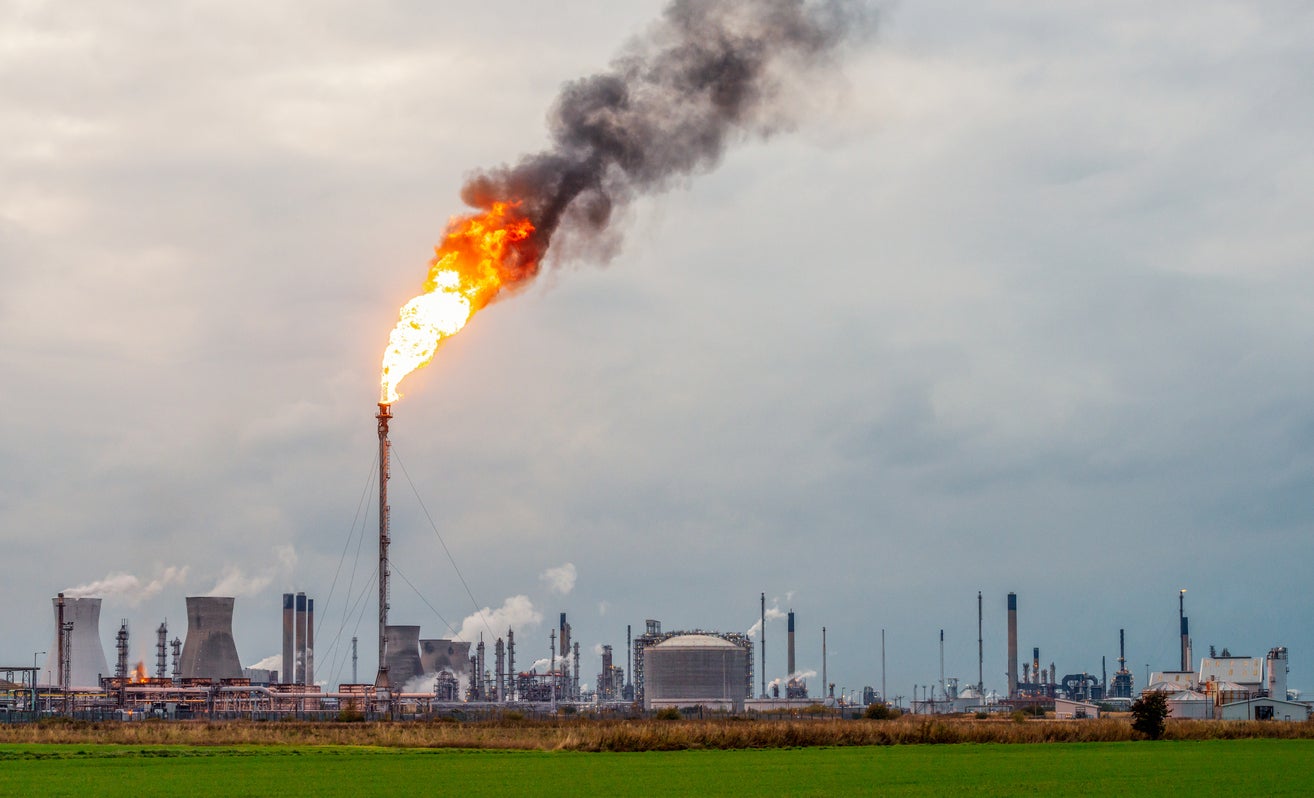 Flames and smoke rising from a flare stack at Grangemouth oil refinery and petrochemical plant in Scotland