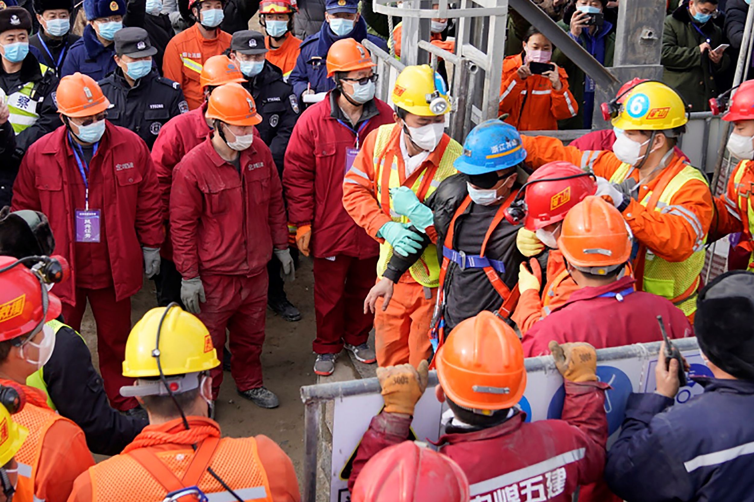 One (blue helmet) of the 22 miners rescued from hundreds of metres underground in a gold mine in China&nbsp;