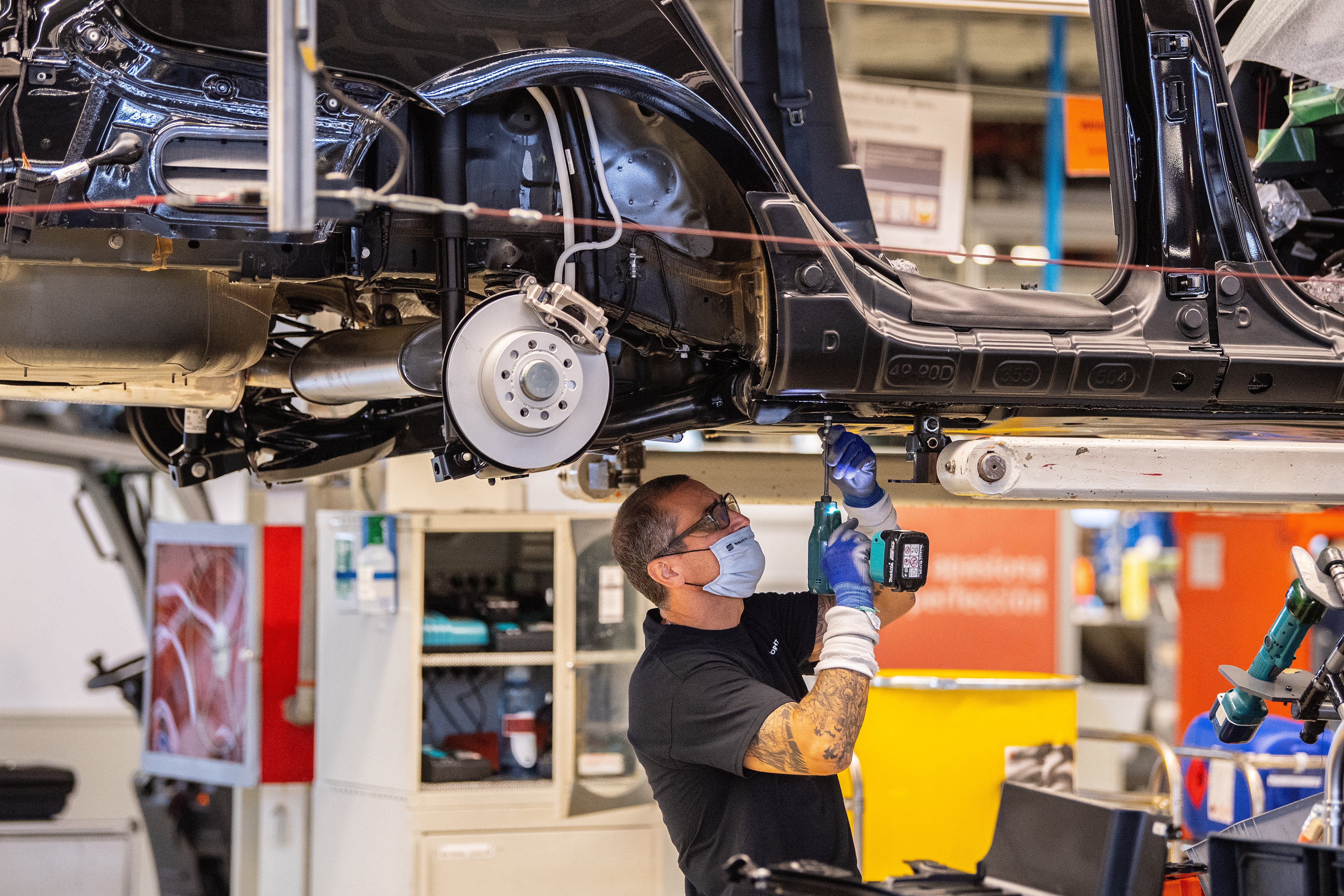 An employee works on the assembly at a SEAT factory in Martorell, Spain. Some Spanish companies are set to get state support to move to a four-day week as part of a government pilot programme