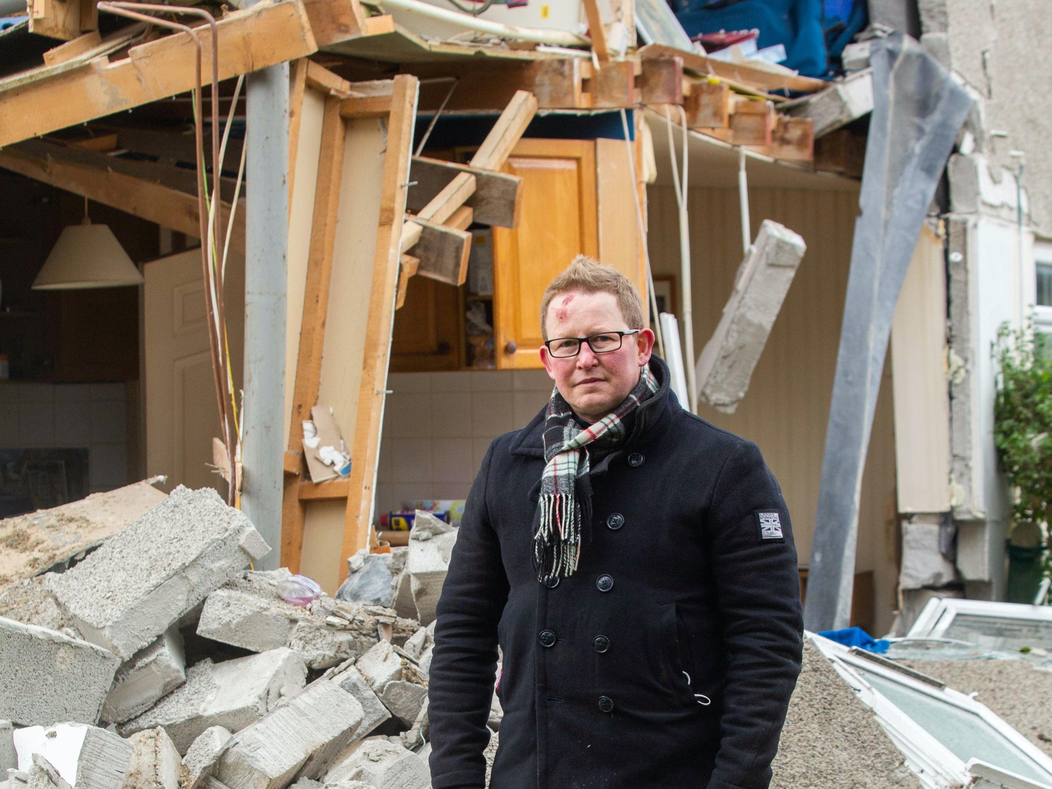 Darren Cornish outside his parents’ ruined home in Bude