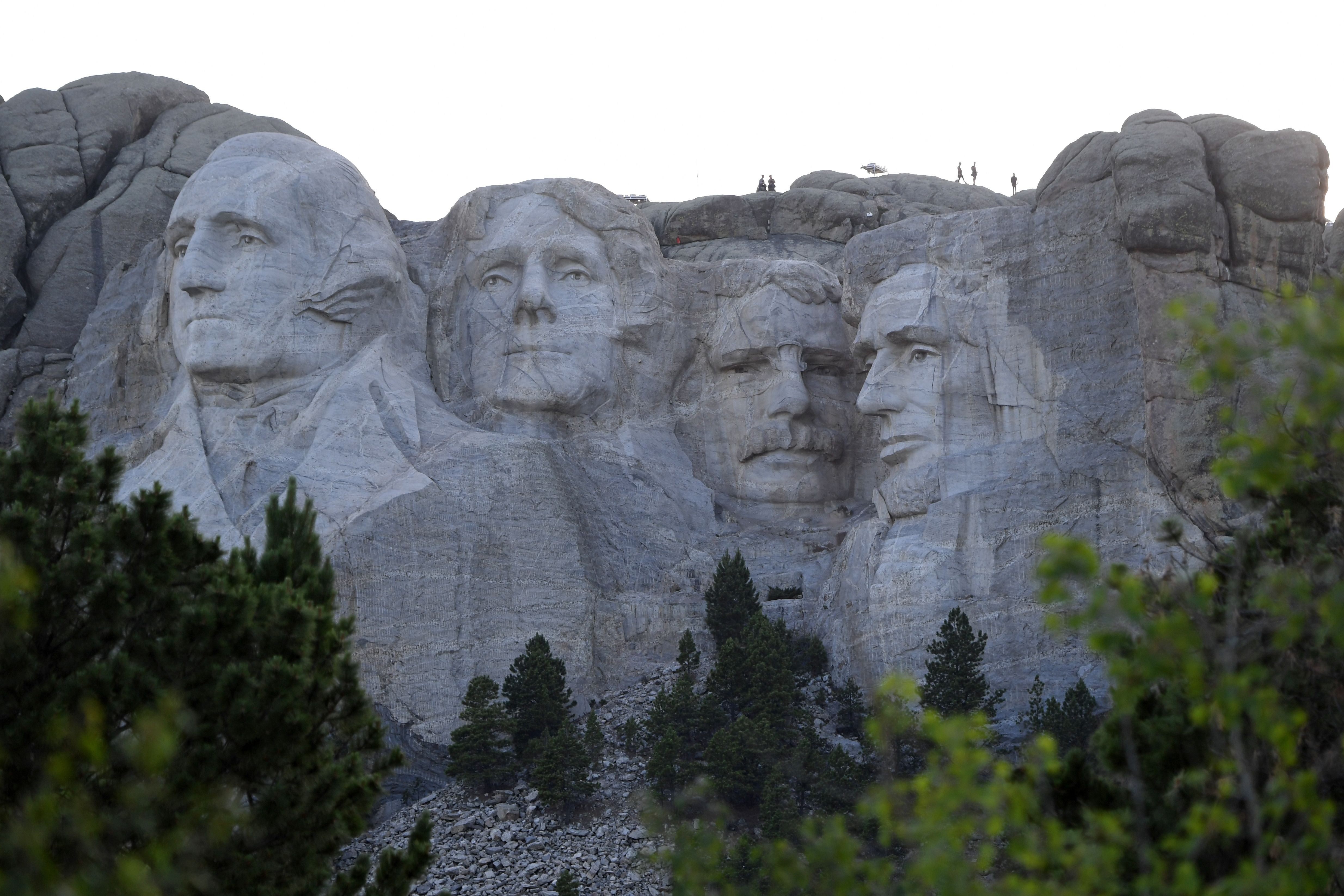 U.S. presidents George Washington, Thomas Jefferson, Theodore Roosevelt and Abraham Lincoln are represented at the Mount Rushmore National Memorial in Keystone, South Dakota, with this image being taken during a visit from former President Donald Trump on 3 July, 2020. Schools named after Washington and Lincoln are set to have their names changed.