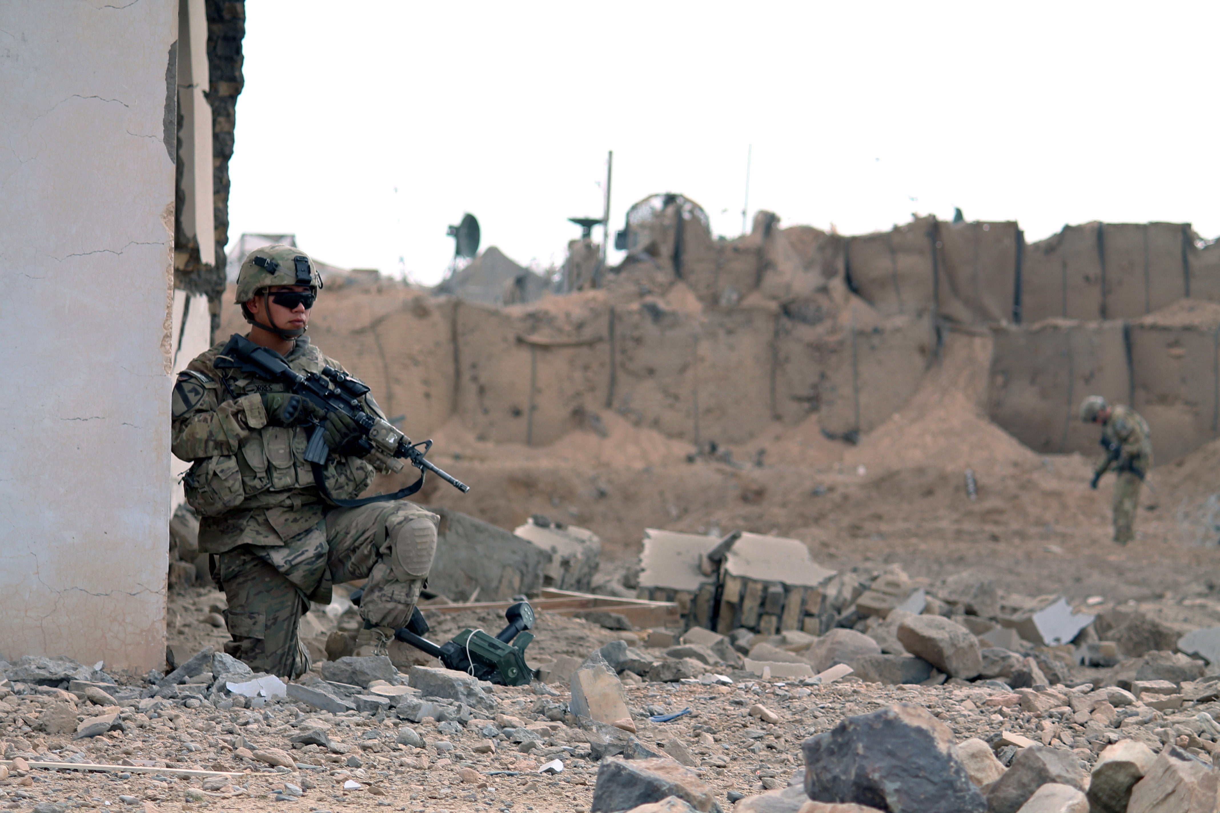 A US soldier at the scene of a suicide attack outside a base in Zhari district, Kandahar