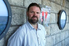 Case dropped against journalist arrested after taking photos of protest outside controversial asylum camp