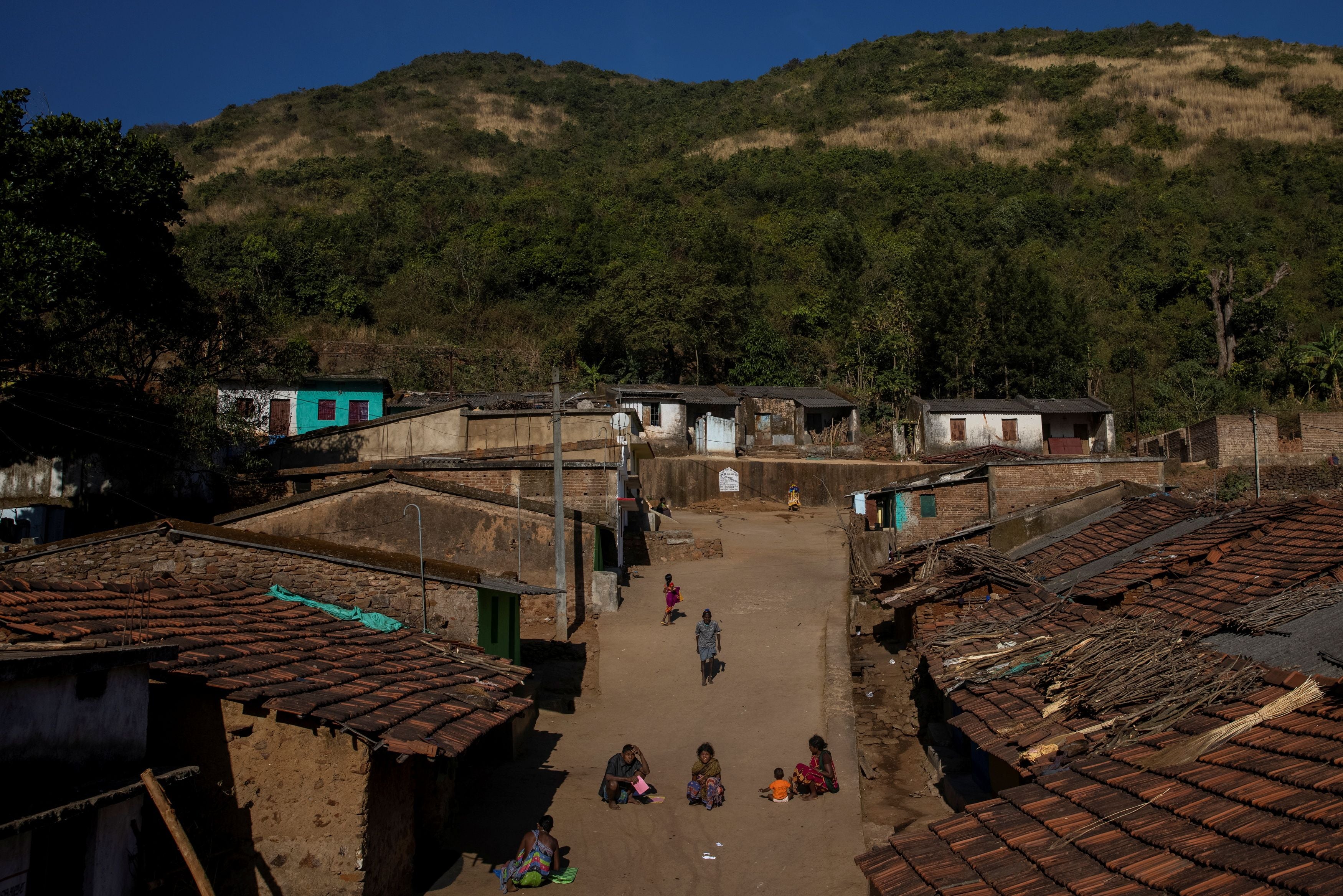 People walk through Pendajam village in Koraput, India