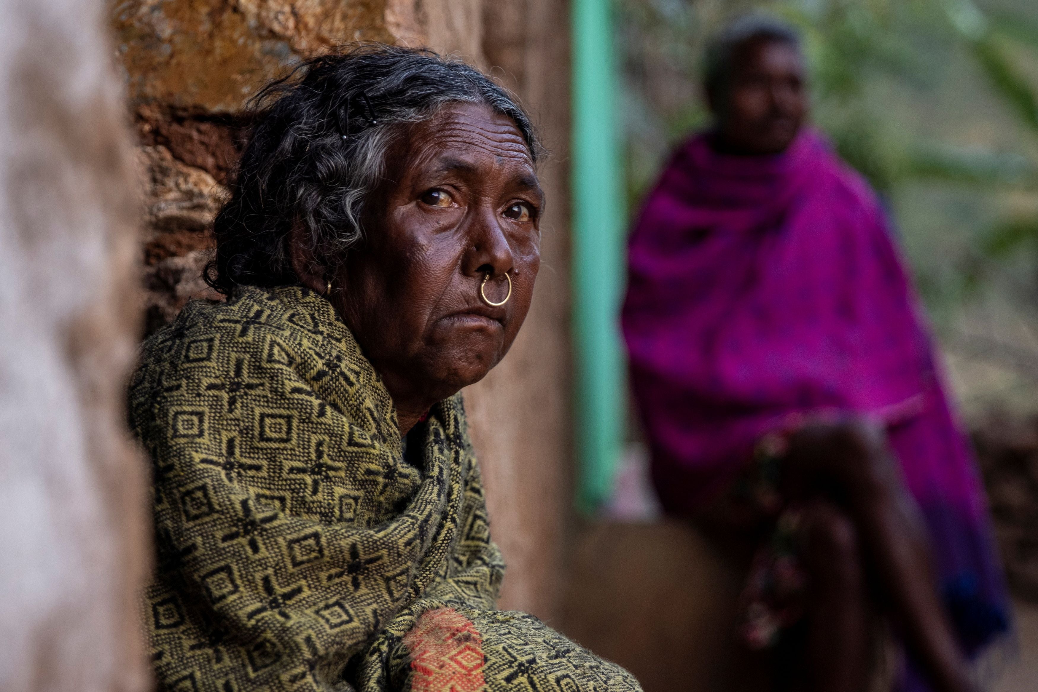 A woman looks out from Pendajam village in Koraput, India