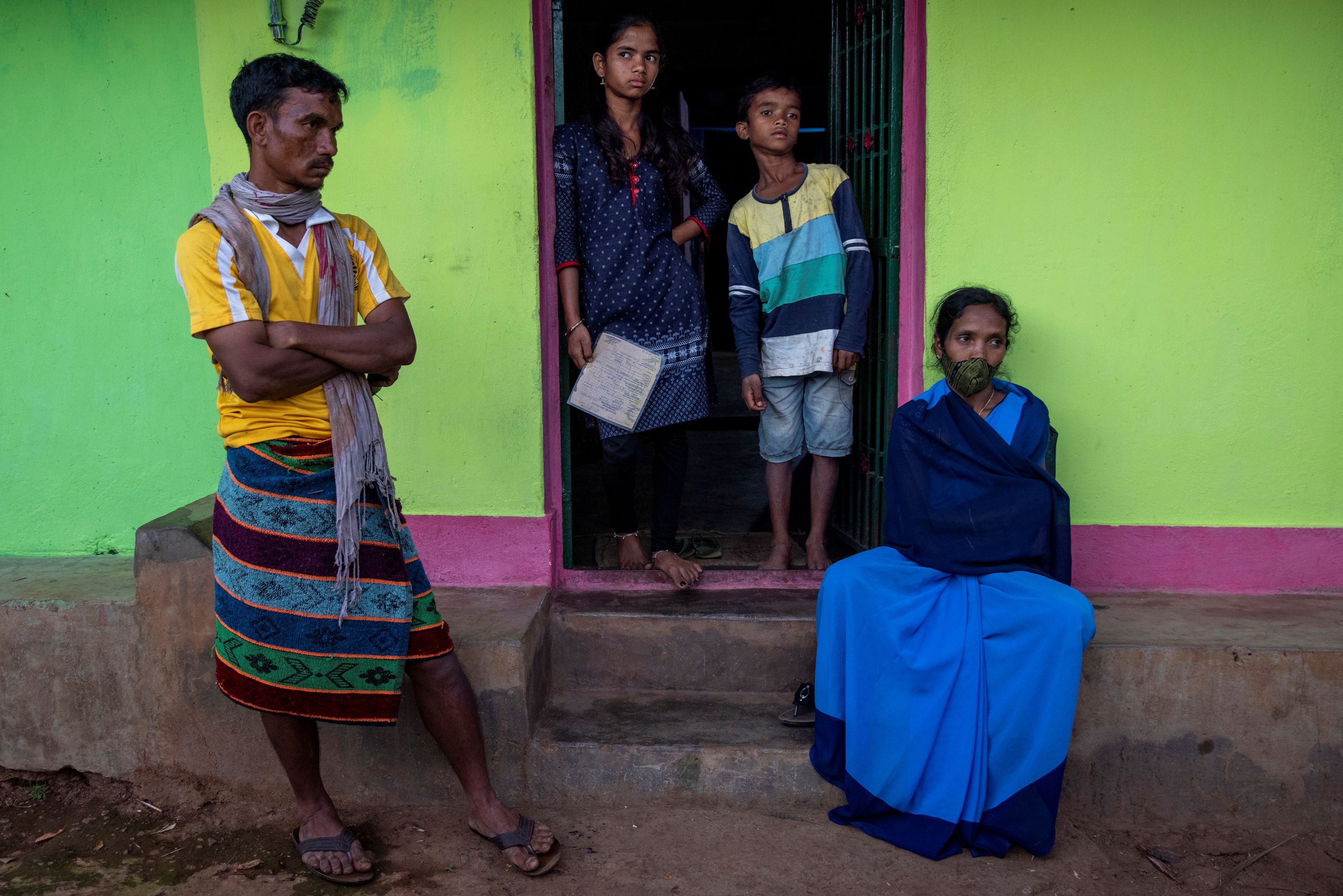 Reena Jani, 34, a health worker, sits outside her home with her husband Suna Jani, 15-year-old daughter Rajani and 10-year-old son Sujeet, a day before receiving the vaccine