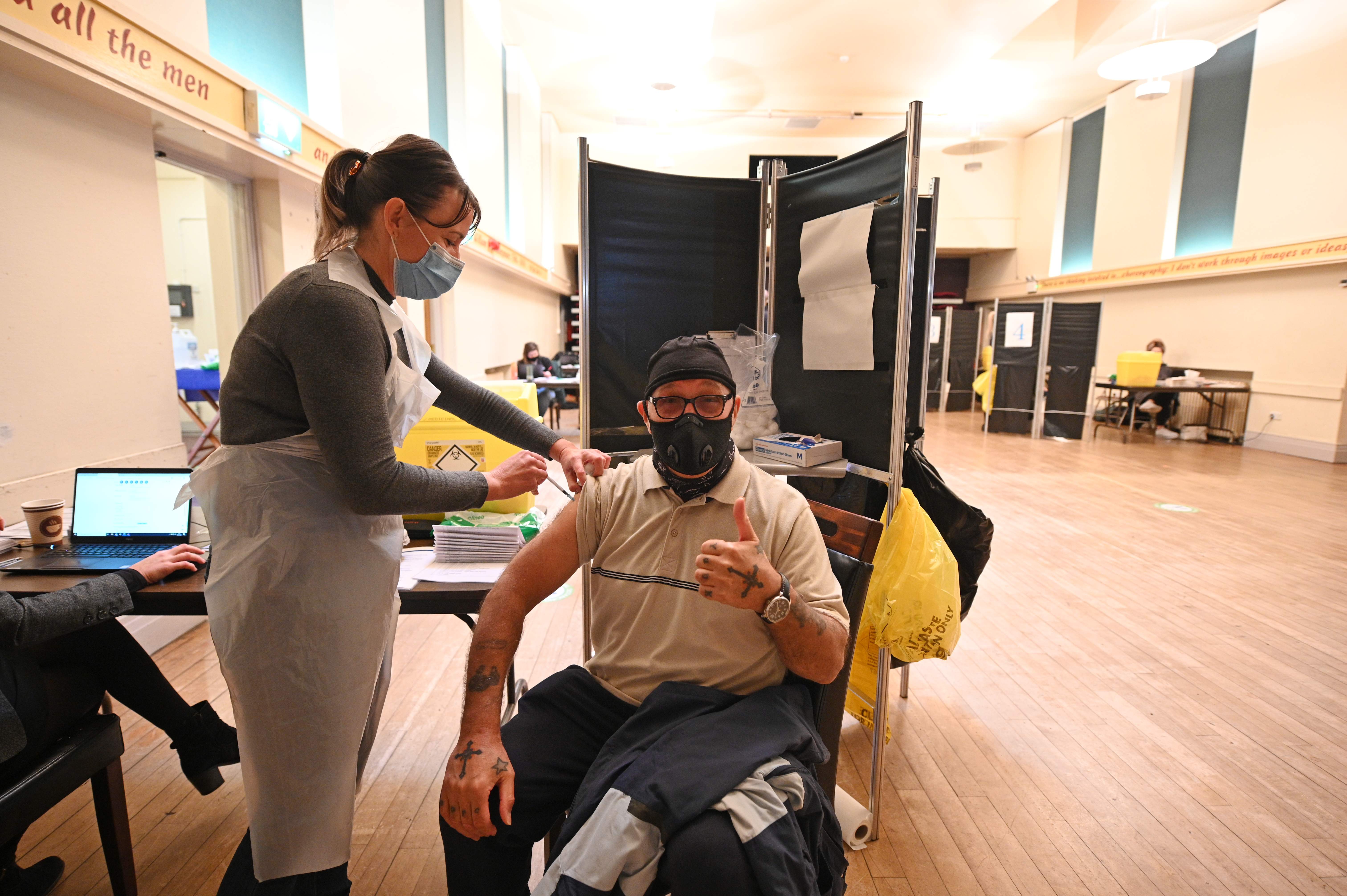 Nurse Francine Millward (left) administers the Pfizer/BioNTech vaccine at a centre set up at Thornton Little Theatre in northwest England