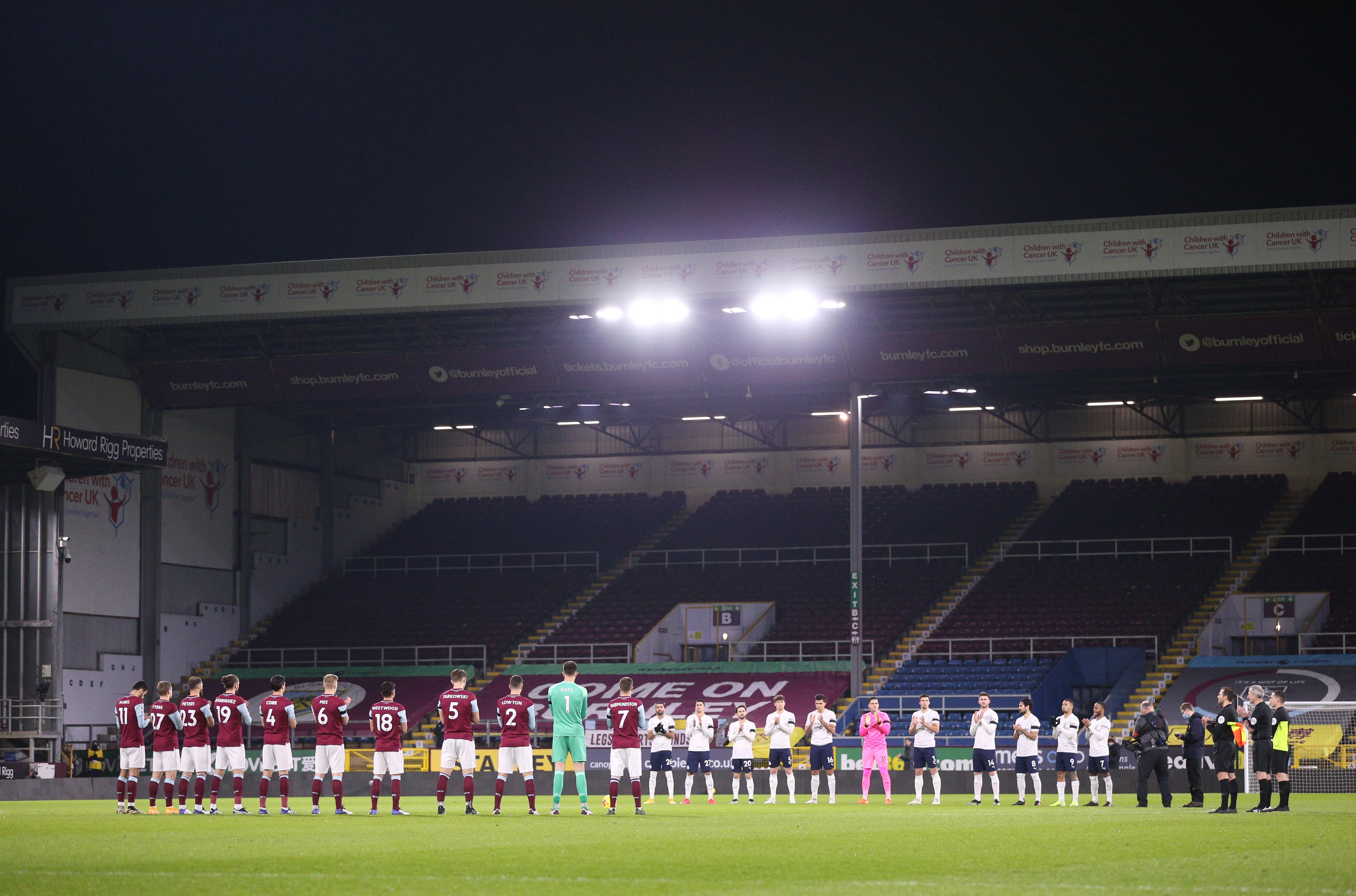 Players from the Premier League Burnley v Manchester City teams line up during a minute’s applause in memory of Captain Sir Tom Moore before the match