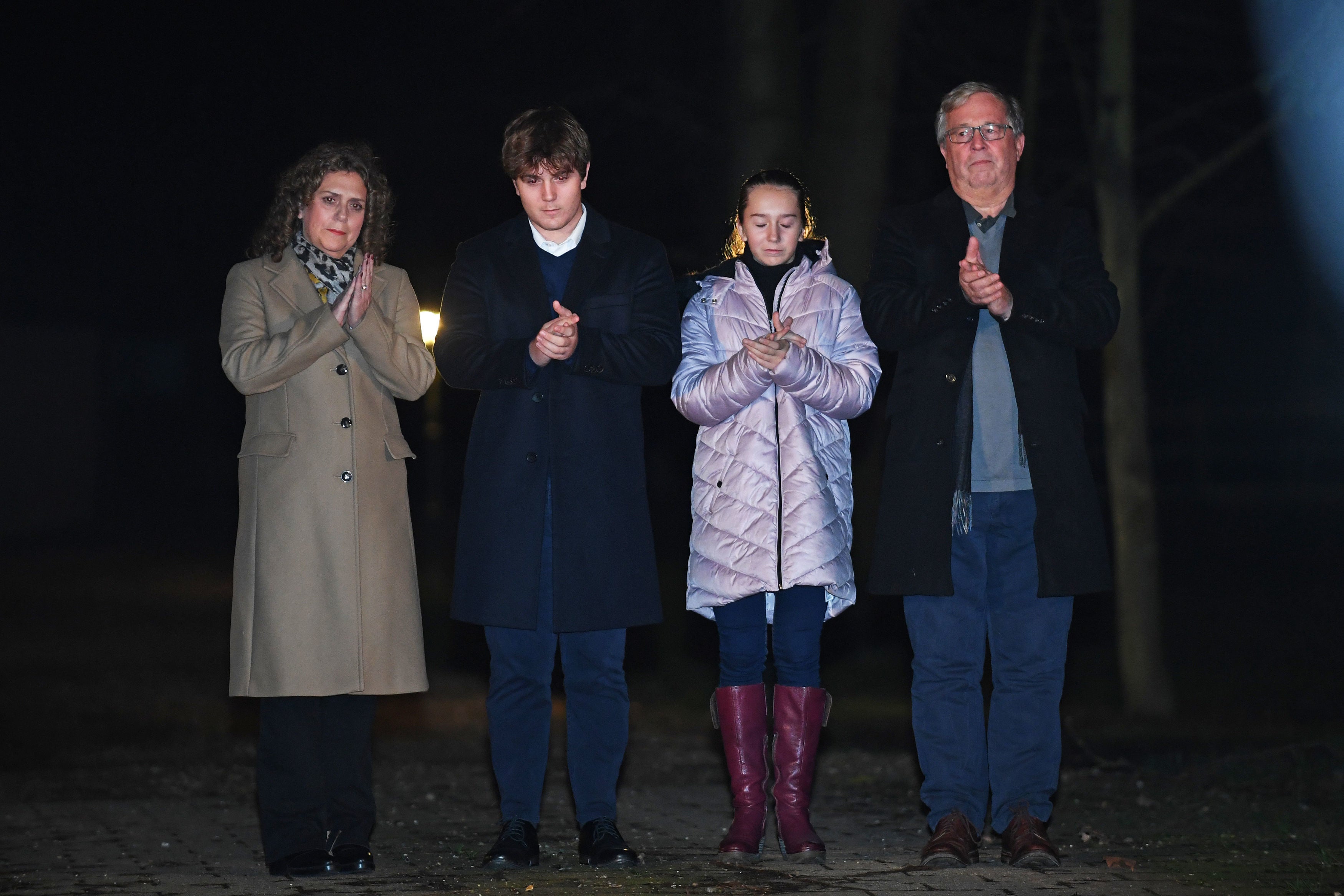 Captain Sir Tom Moore's daughter Hannah Ingram-Moore, grandson Benji, granddaughter Georgia and son-in-law Colin Ingram outside his the home in Marston Moretaine, Bedfordshire, joining in with a nationwide clap