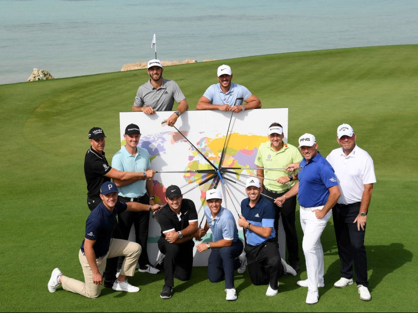 Golfers pose in front of a map at the inaugural tournament in Saudi Arabia