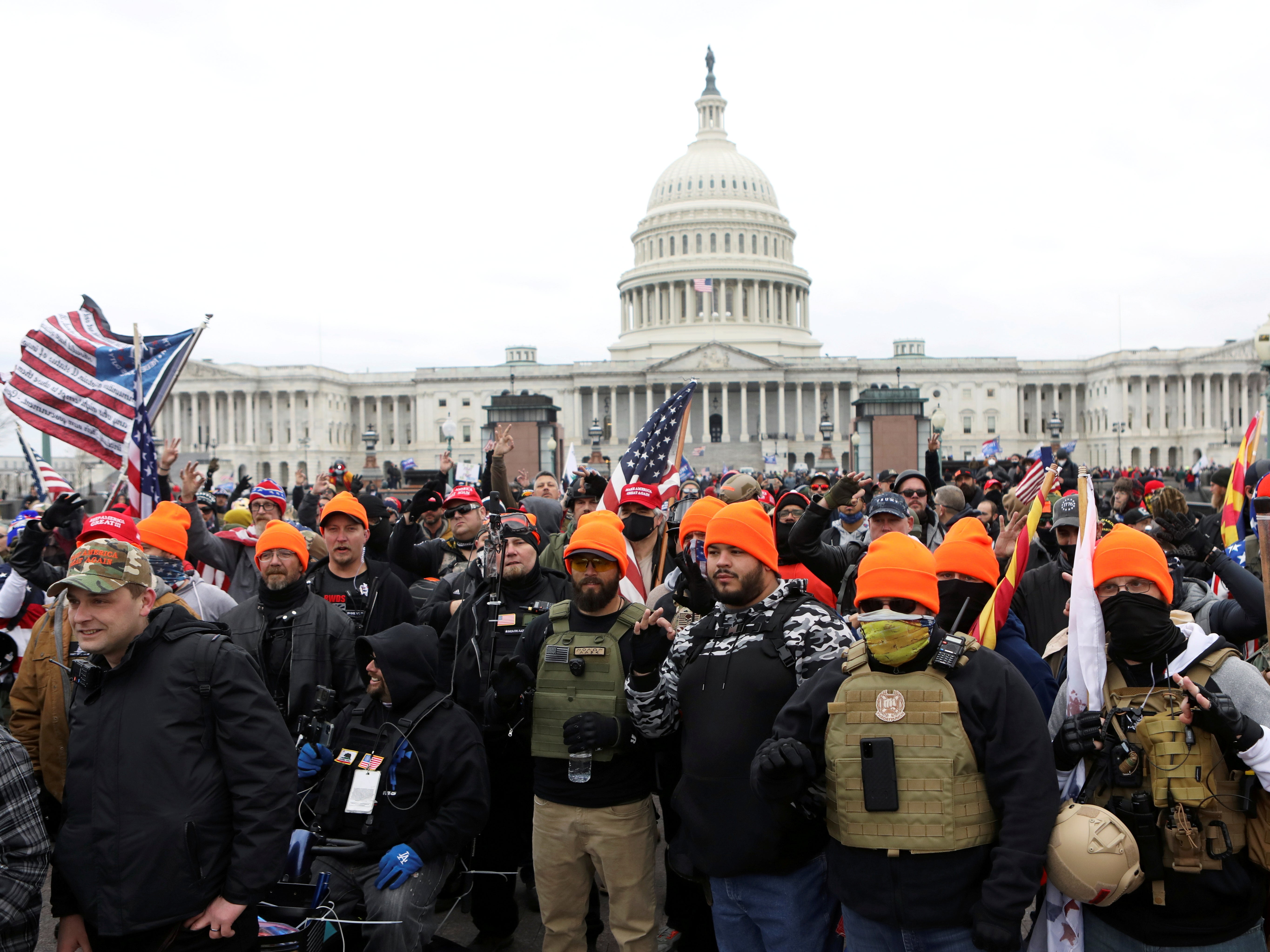 Members of the far-right group Proud Boys make 'OK' hand gestures indicating "white power"