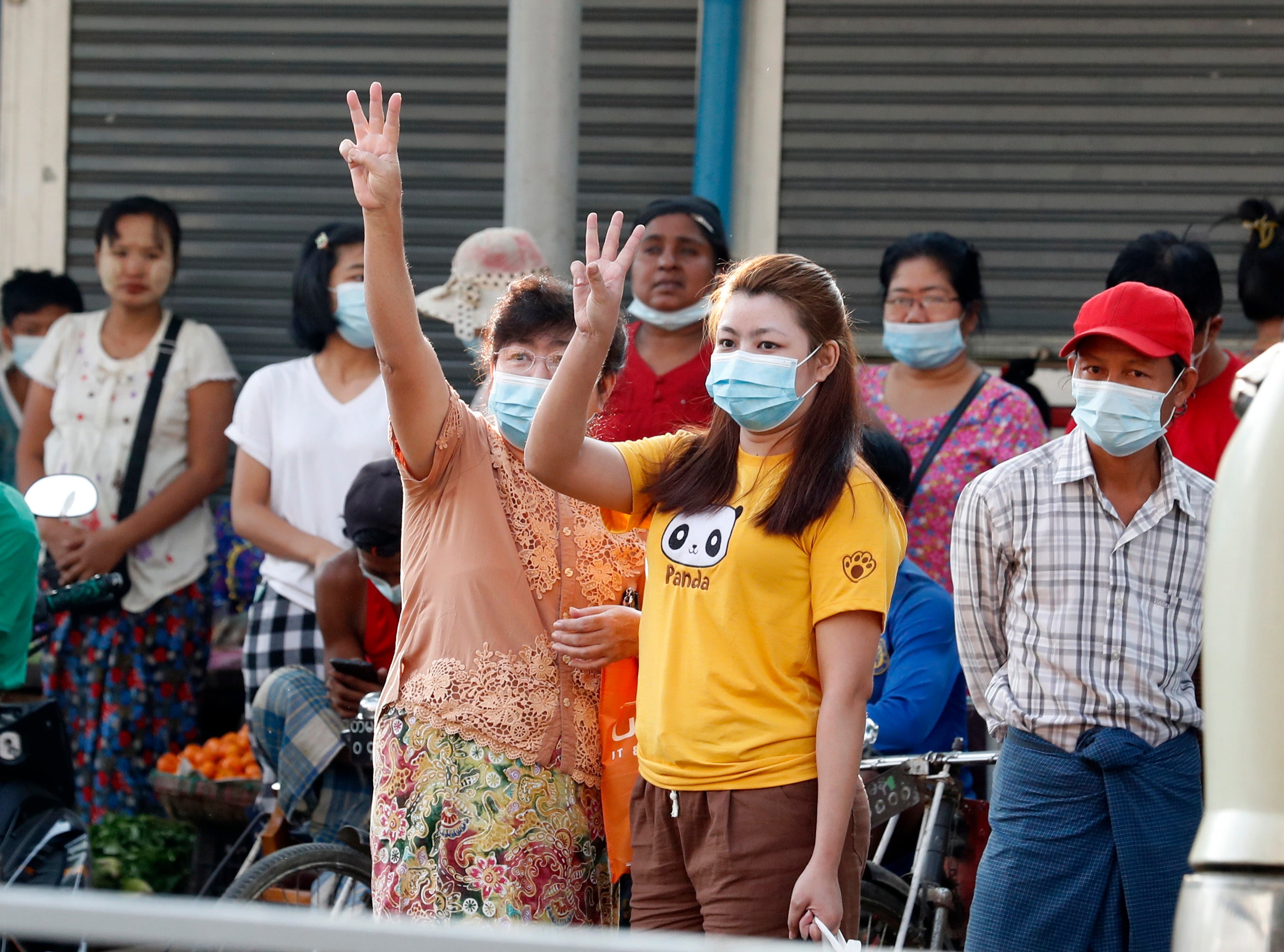 Myanmar women flash the three finger salute as they protest against the Coup in Yangon, Myanmar, 04 February 2021