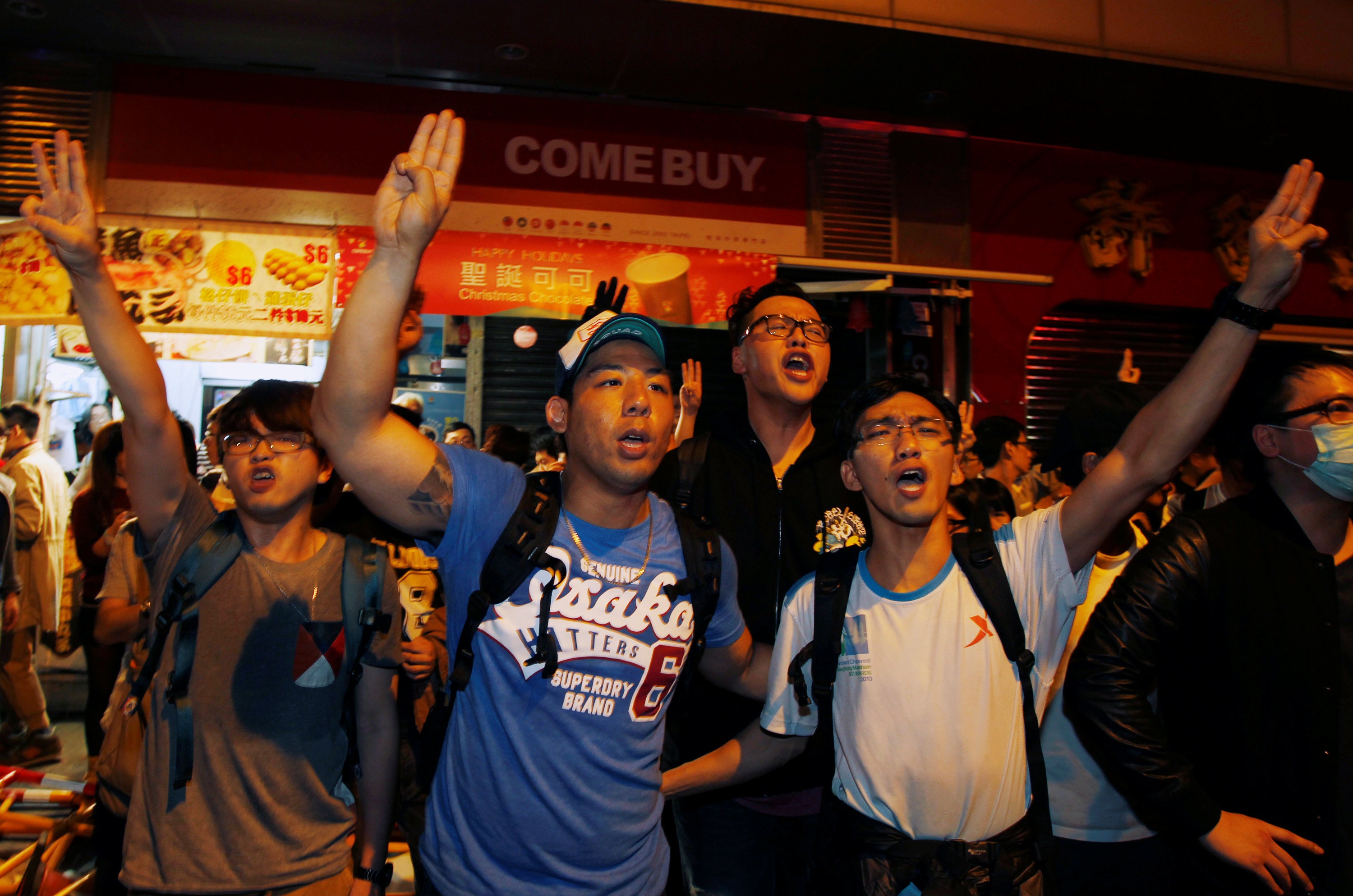 File photo: Pro-democracy protesters chant slogans as they imitate a three-finger salute from movie "The Hunger Games" during a confrontation with the police at Mongkok shopping district in Hong Kong