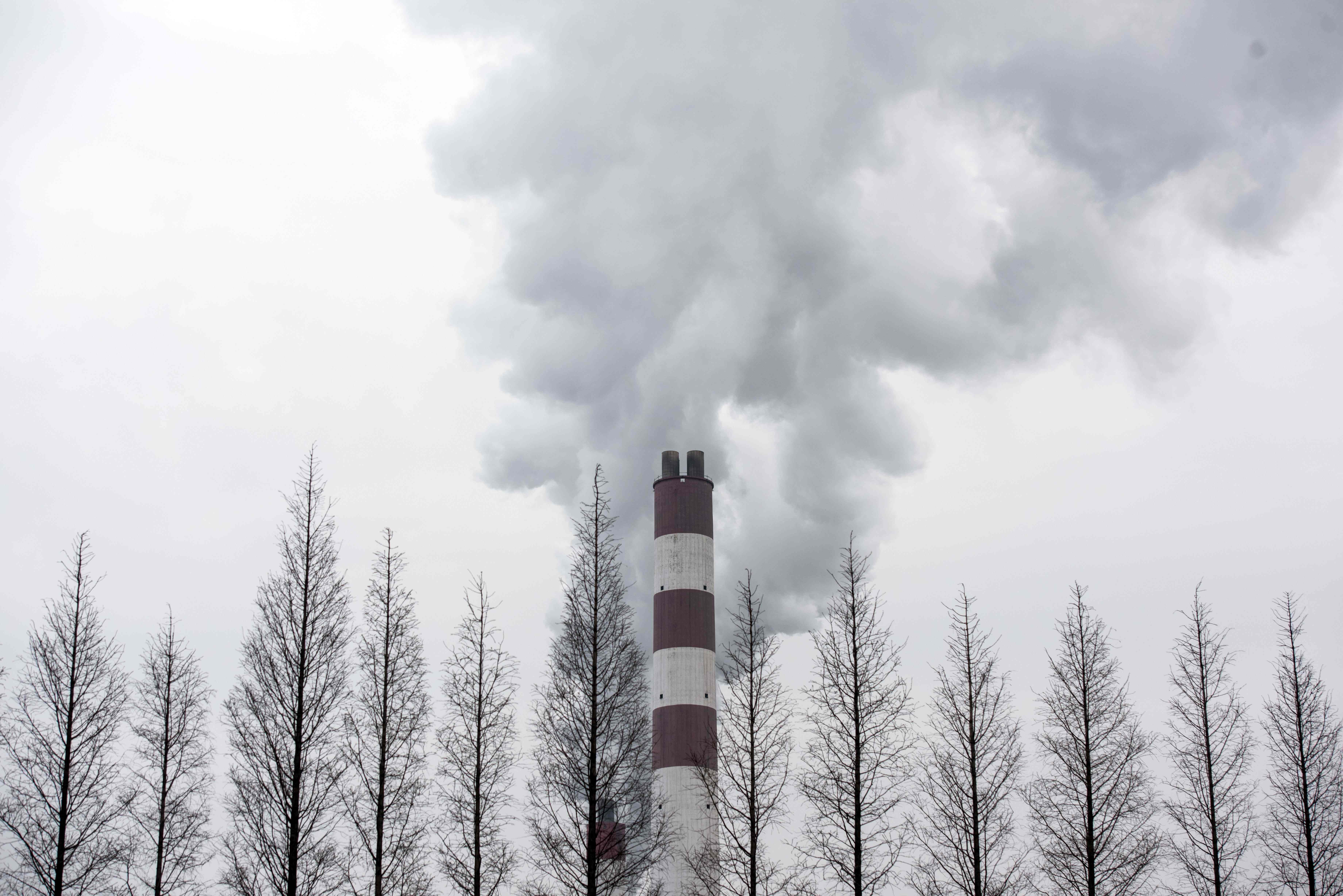 File: Smoke billowing from a chimney of the Shanghai Waigaoqiao Power Generator Company coal power plant in Shanghai