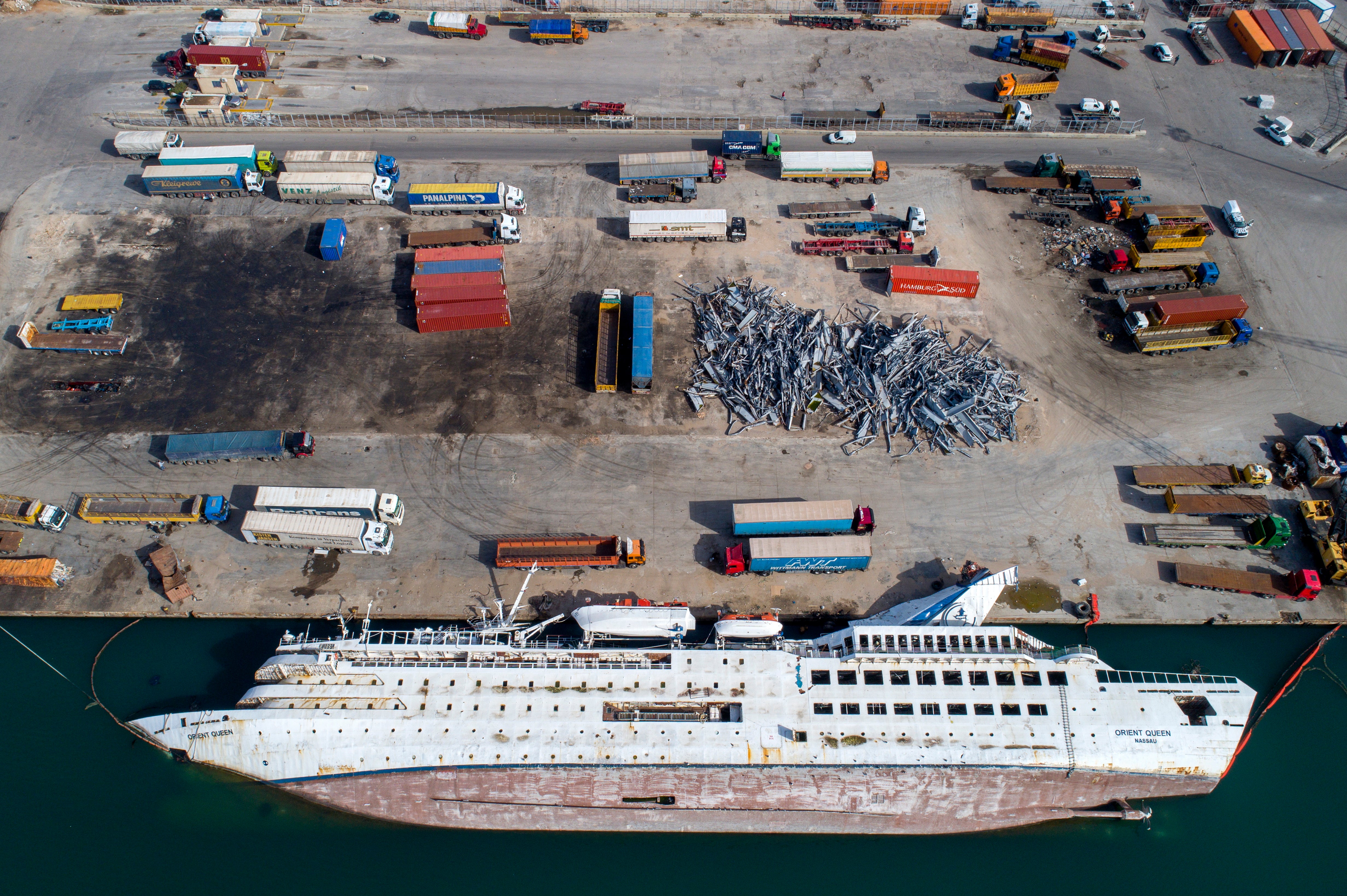 A beached cruise liner lies on its side in Beirut’s destroyed port