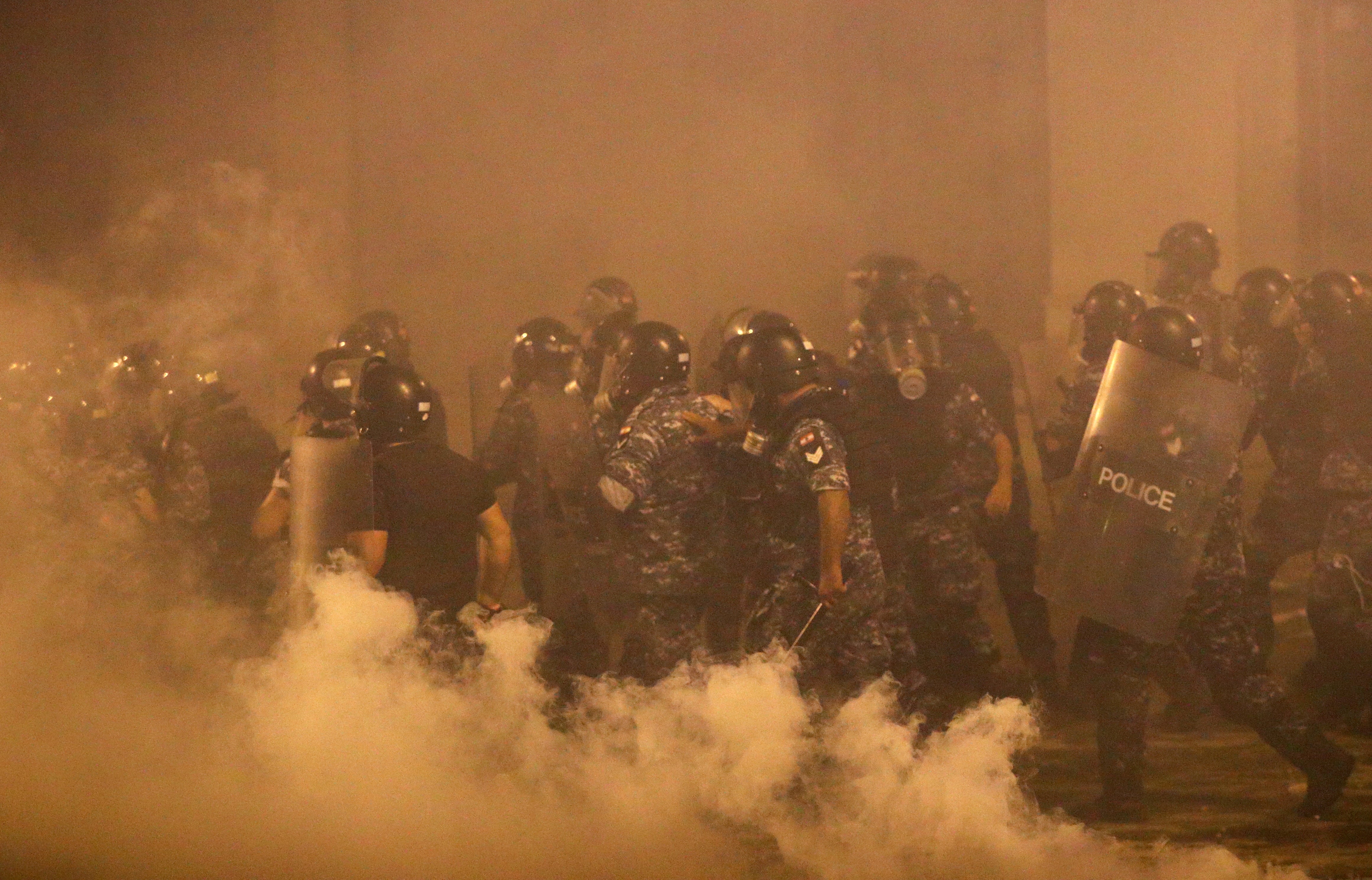 Police officers are seen during a Beirut protest days after the blast