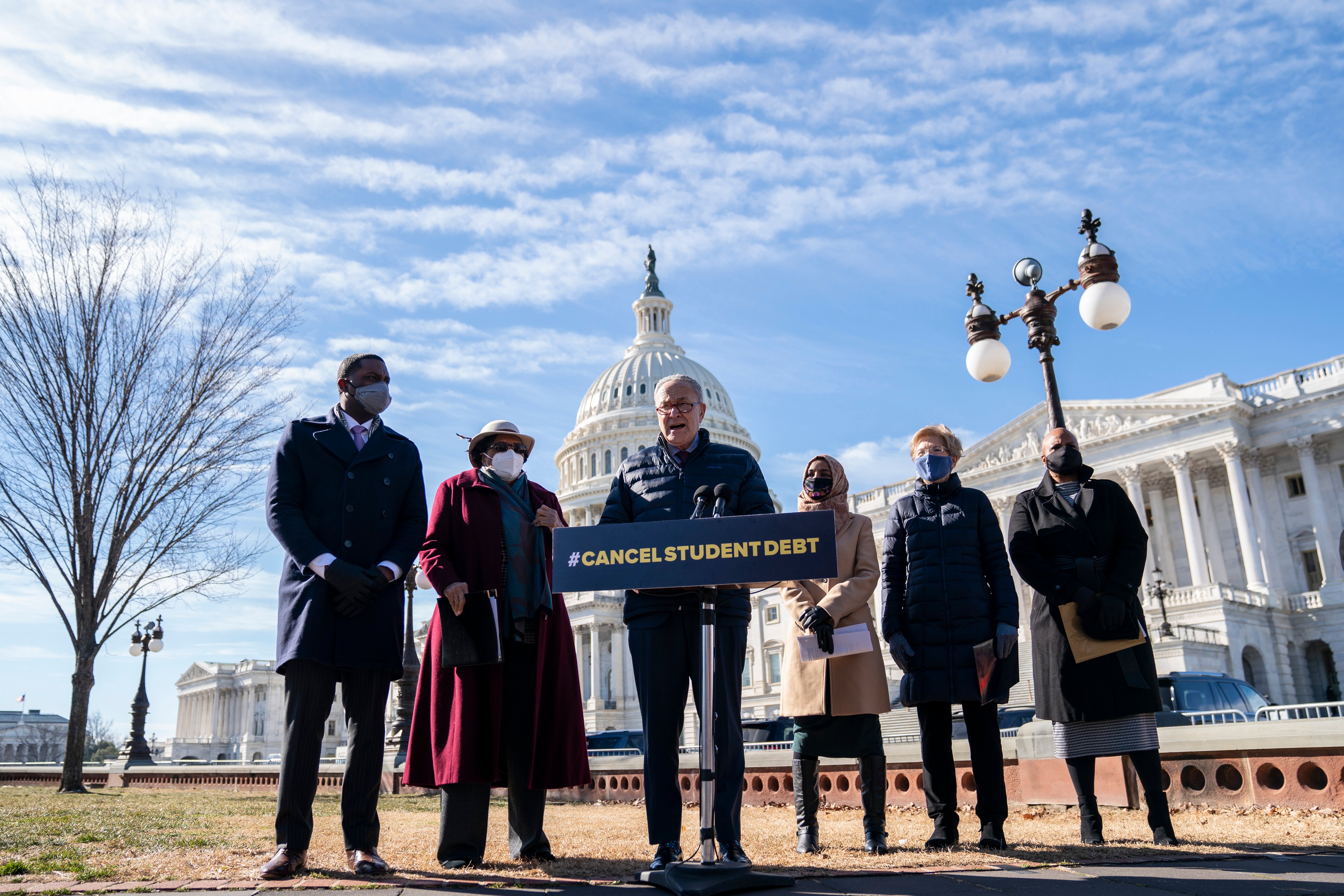 Senator Chuck Schumer, accompanied by from left, Representatives Mondaire Jones, Alma Adams, Ilhan Omar, Senator Elizabeth Warren, and Represenative Ayanna Pressley, in February when they called on Mr Biden to cancel student debt