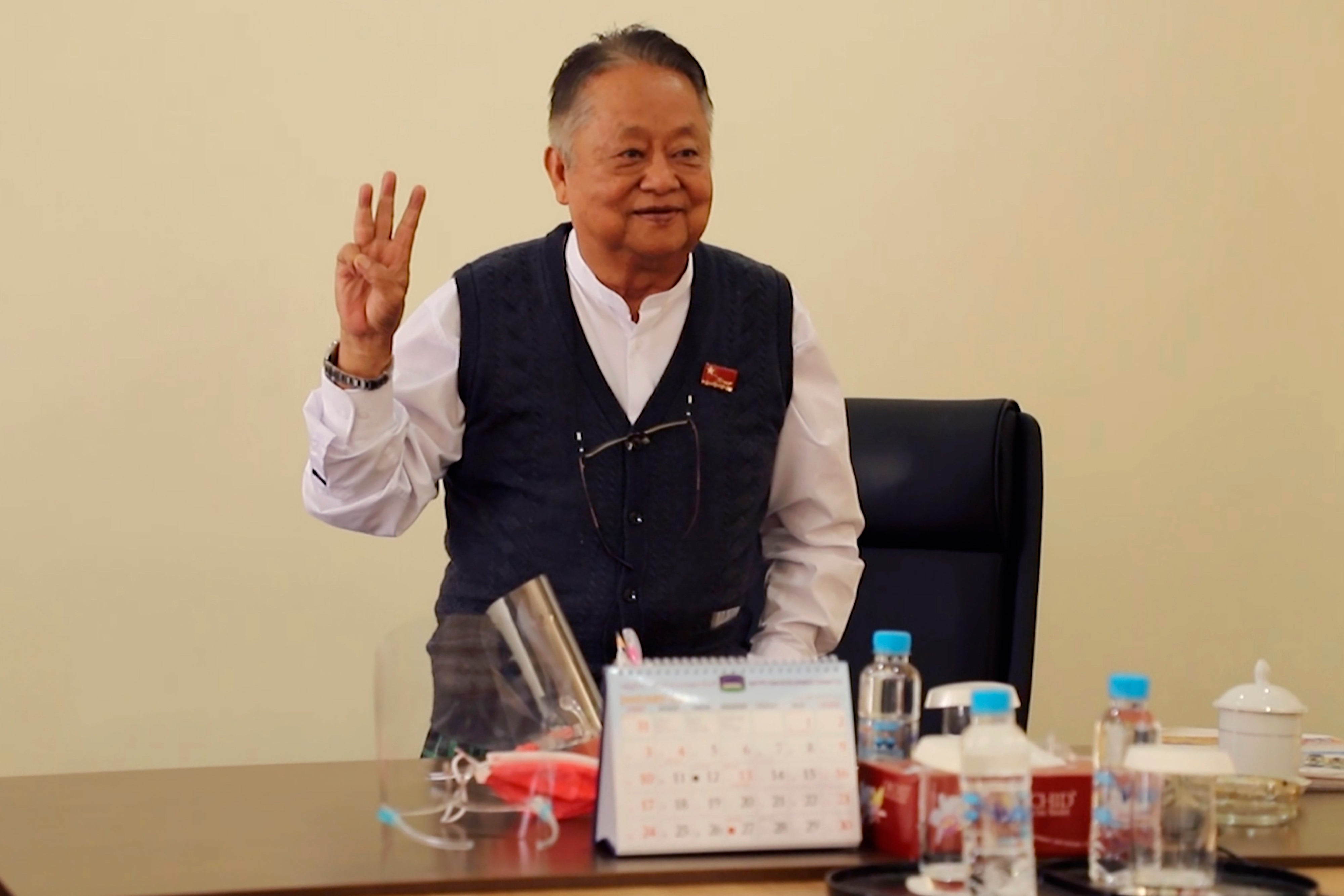 Win Htein flashes the three fingers protest gesture as a symbol of defiance in Naypyitaw, Myanmar