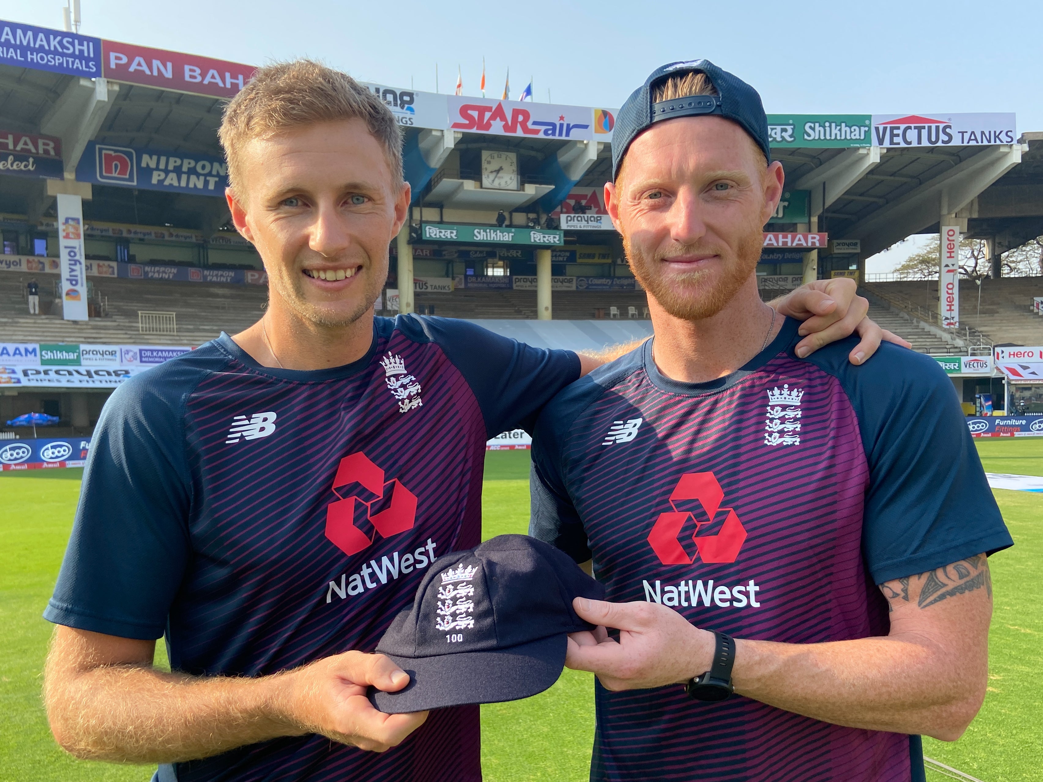 Englan captain Joe Root receives his 100th cap from Ben Stokes