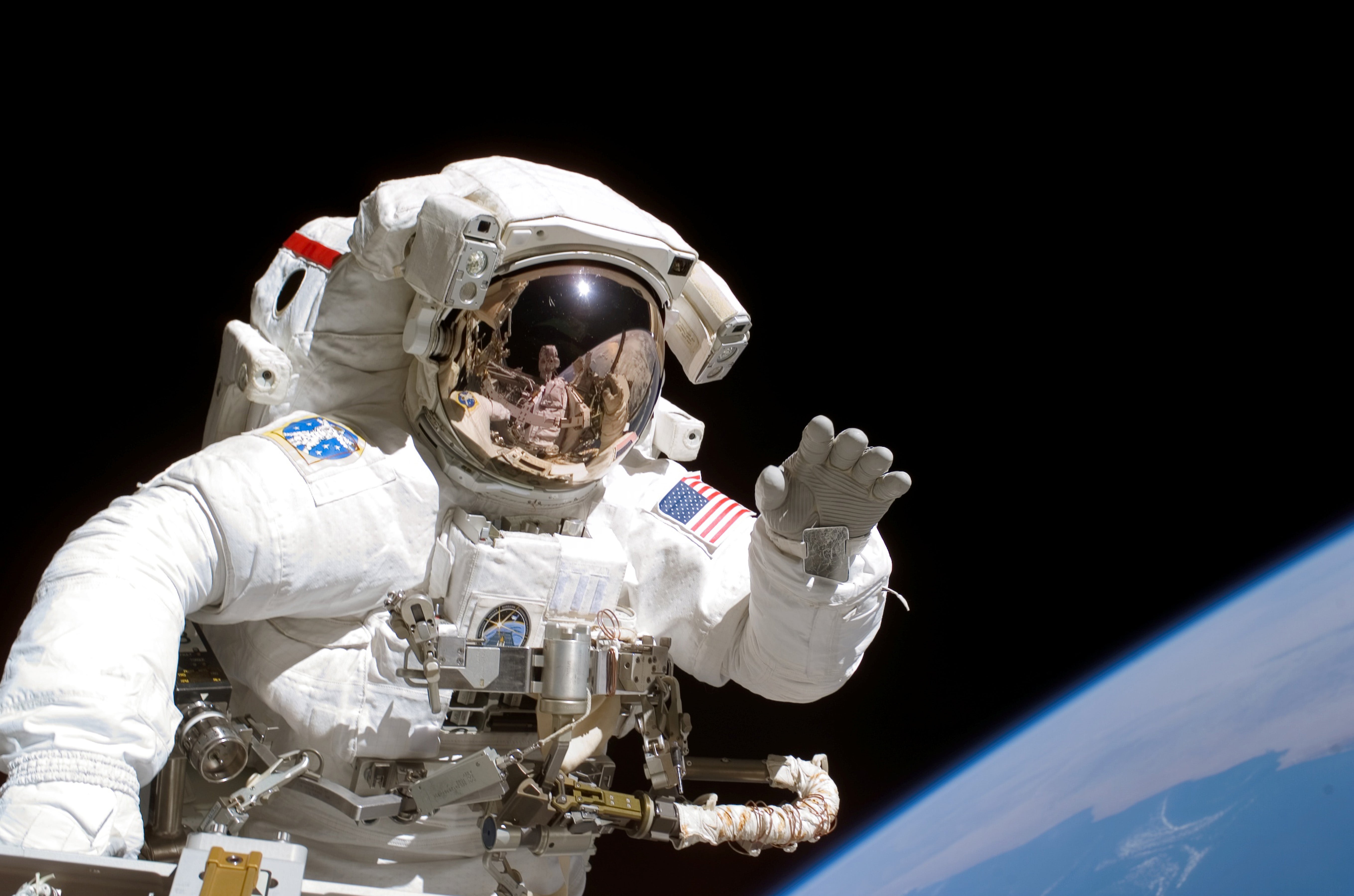 American astronaut Joseph Tanner waves to the camera during a space walk as part of an International Space Station mission in 2006